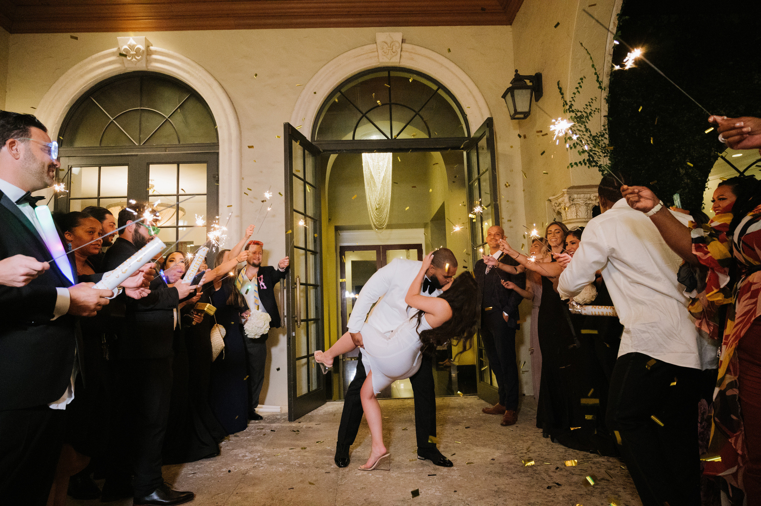 a bride and groom are dancing with sparkle