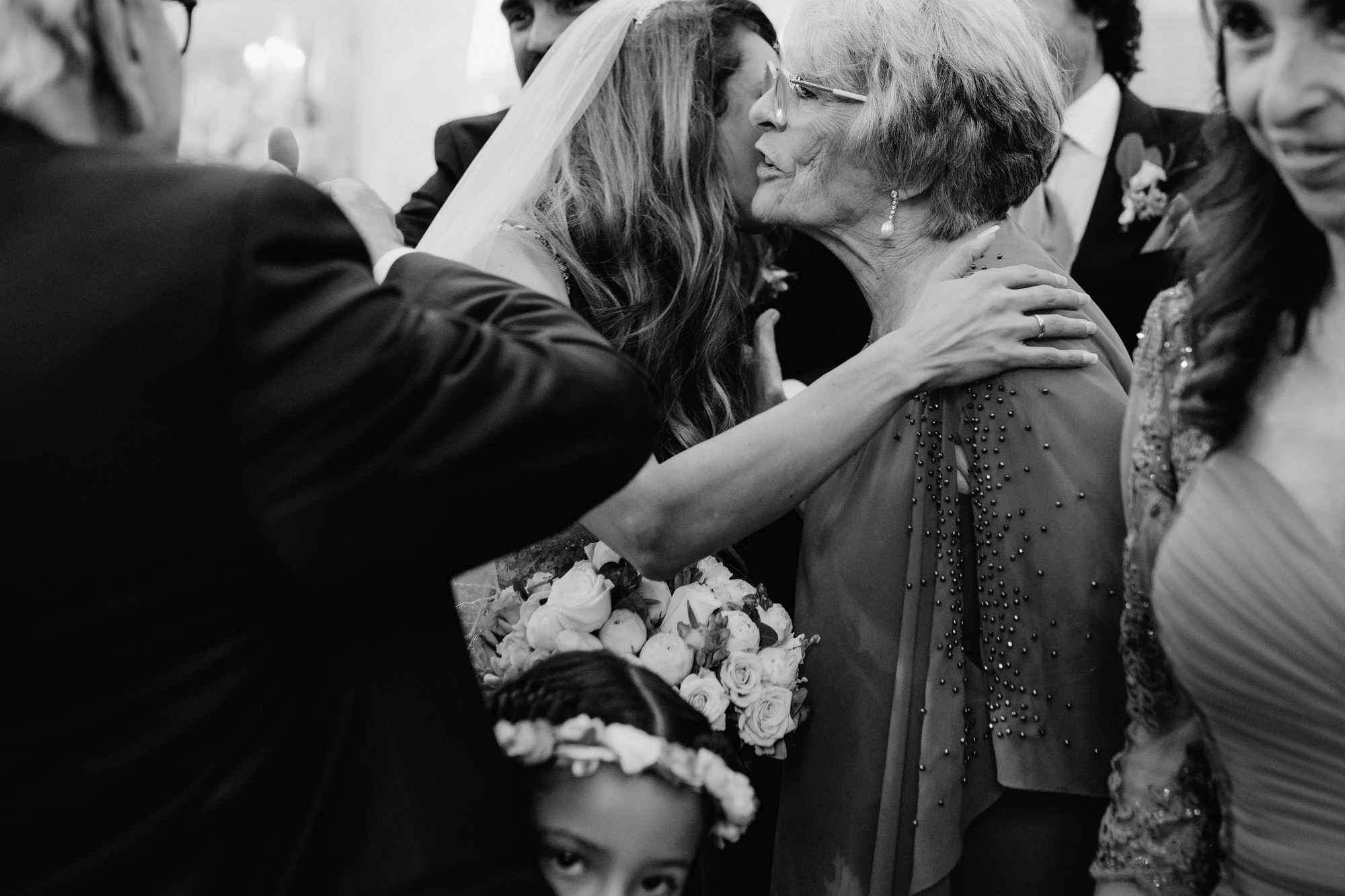 a woman is hugging another woman in a wedding dress