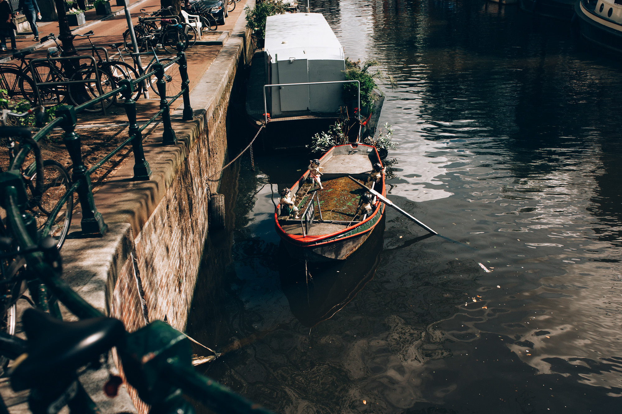a boat is docked on a canal in a city