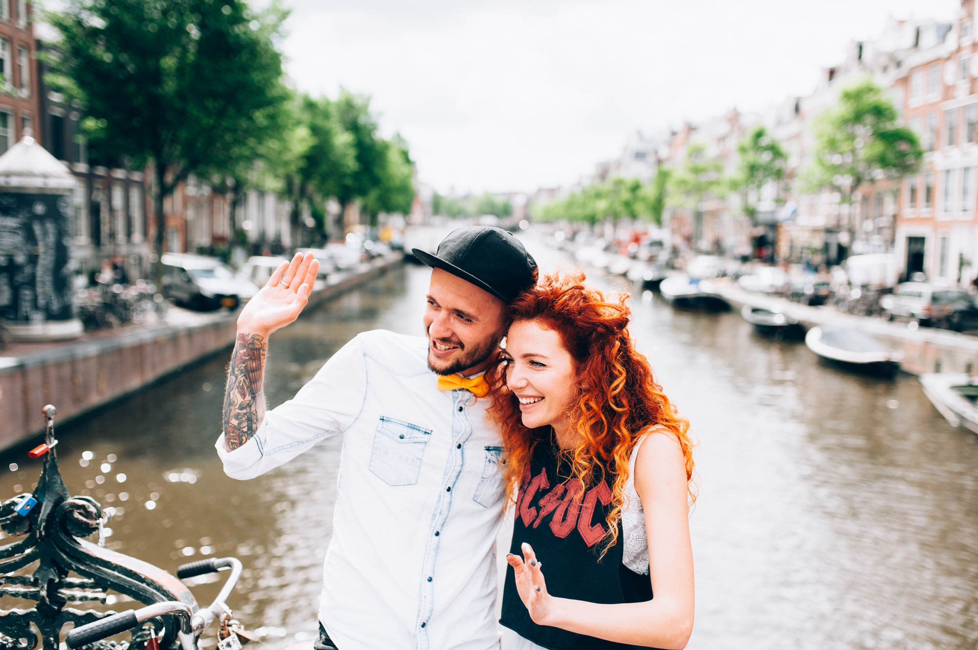 a man and woman are standing on a bridge