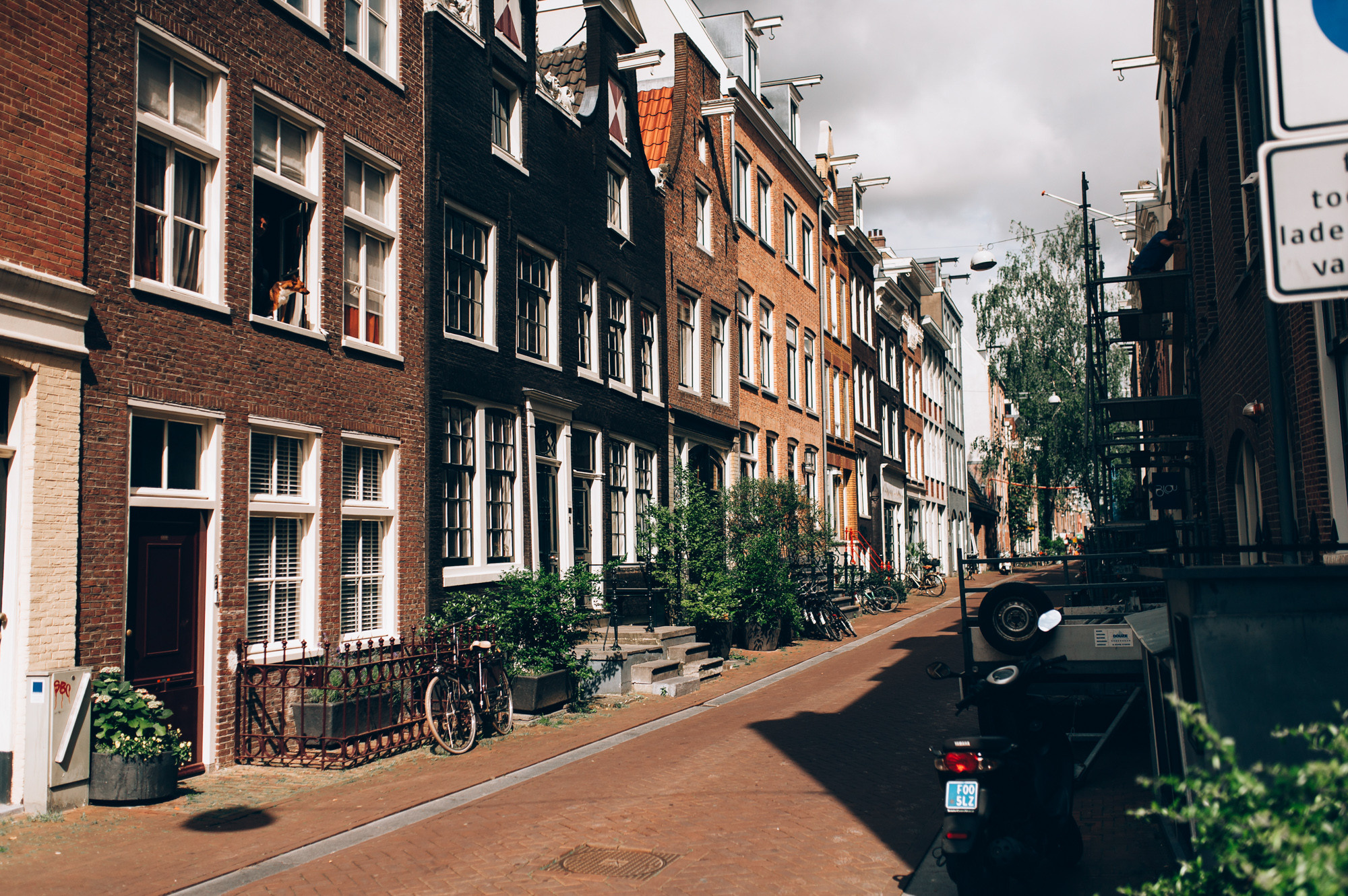 a street with a sign and a bike parked on the side