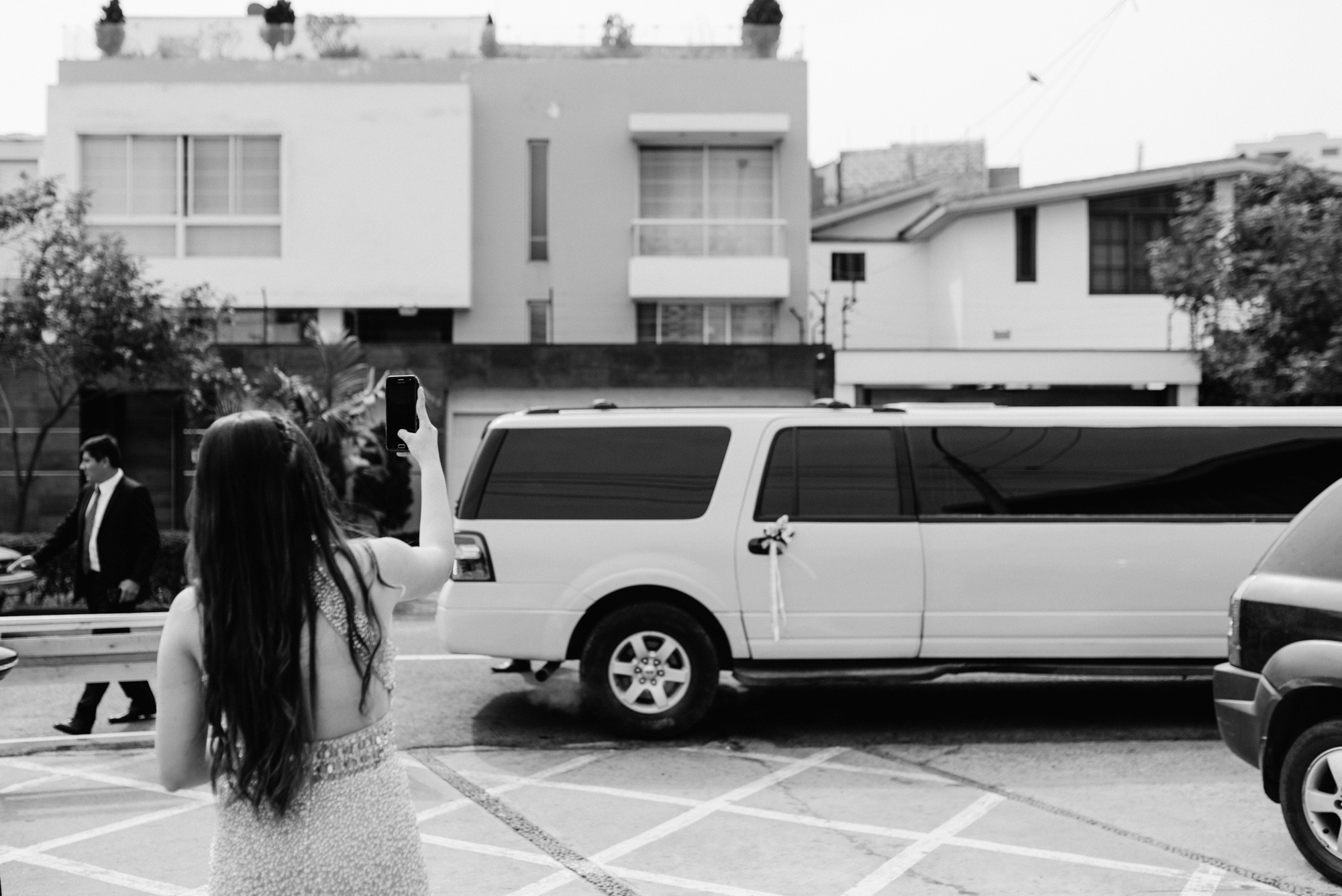 a woman in a dress standing in a parking
