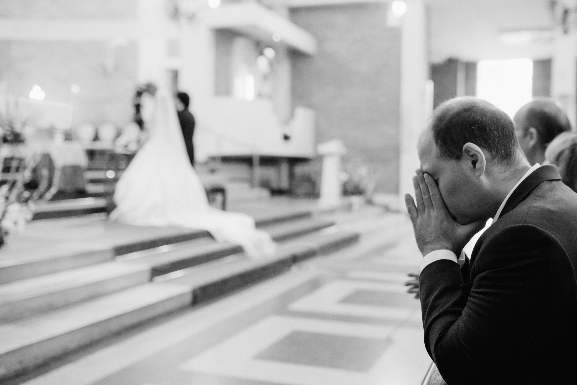 a man in a suit and tie is praying
