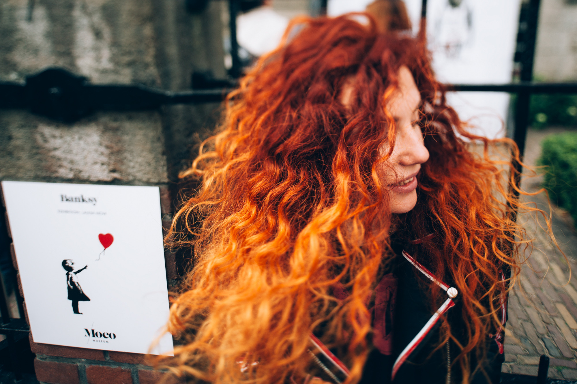 a woman with red hair and a card