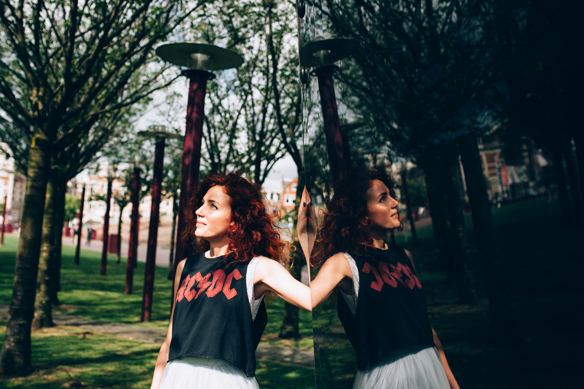 two girls are standing in a park