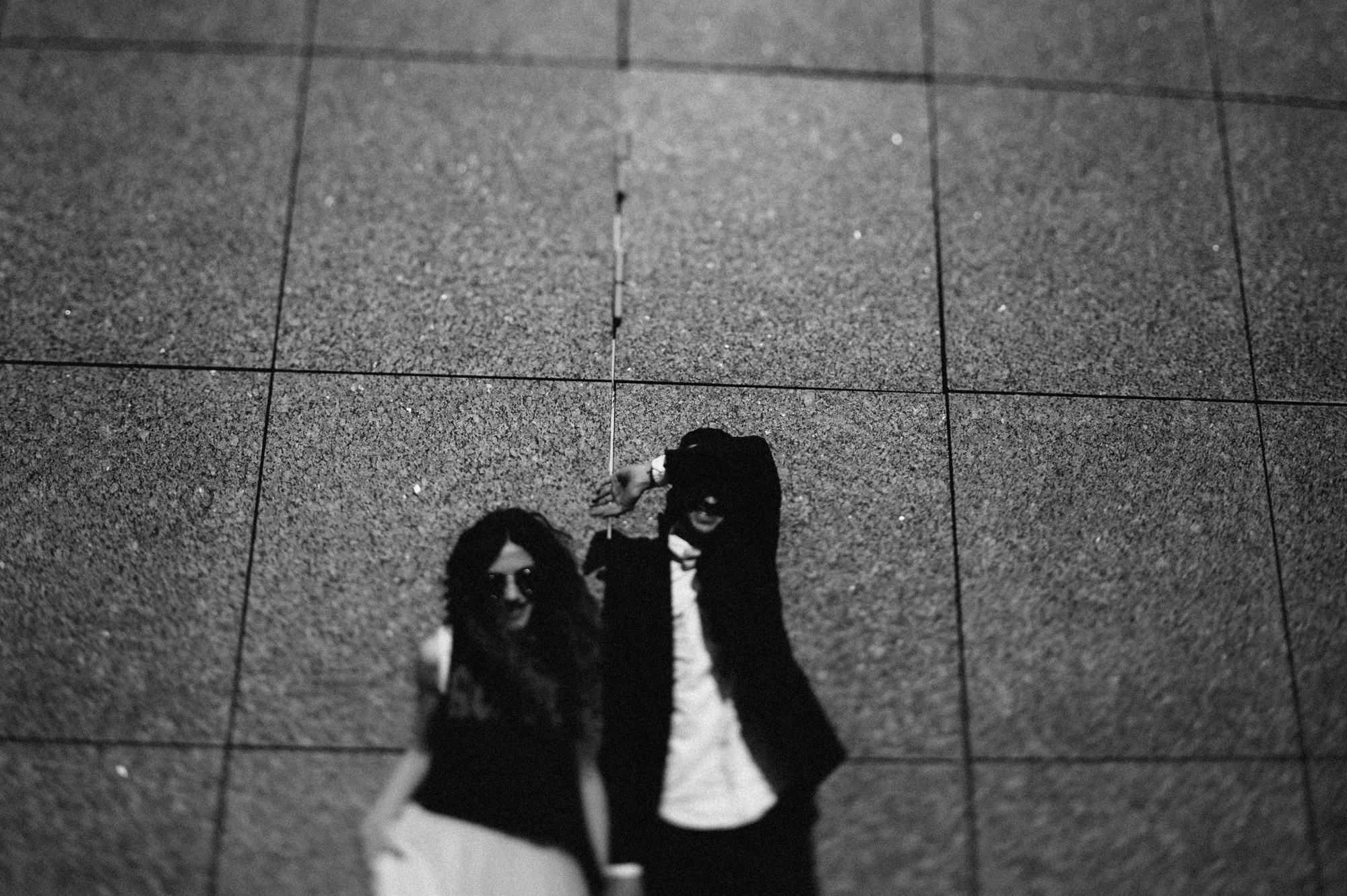 a couple standing on a tiled floor