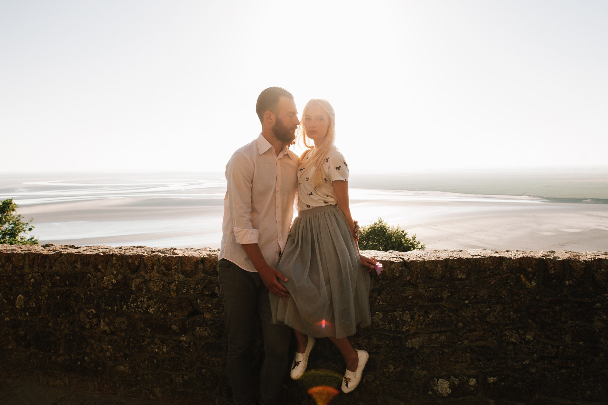 a man and woman standing on a wall