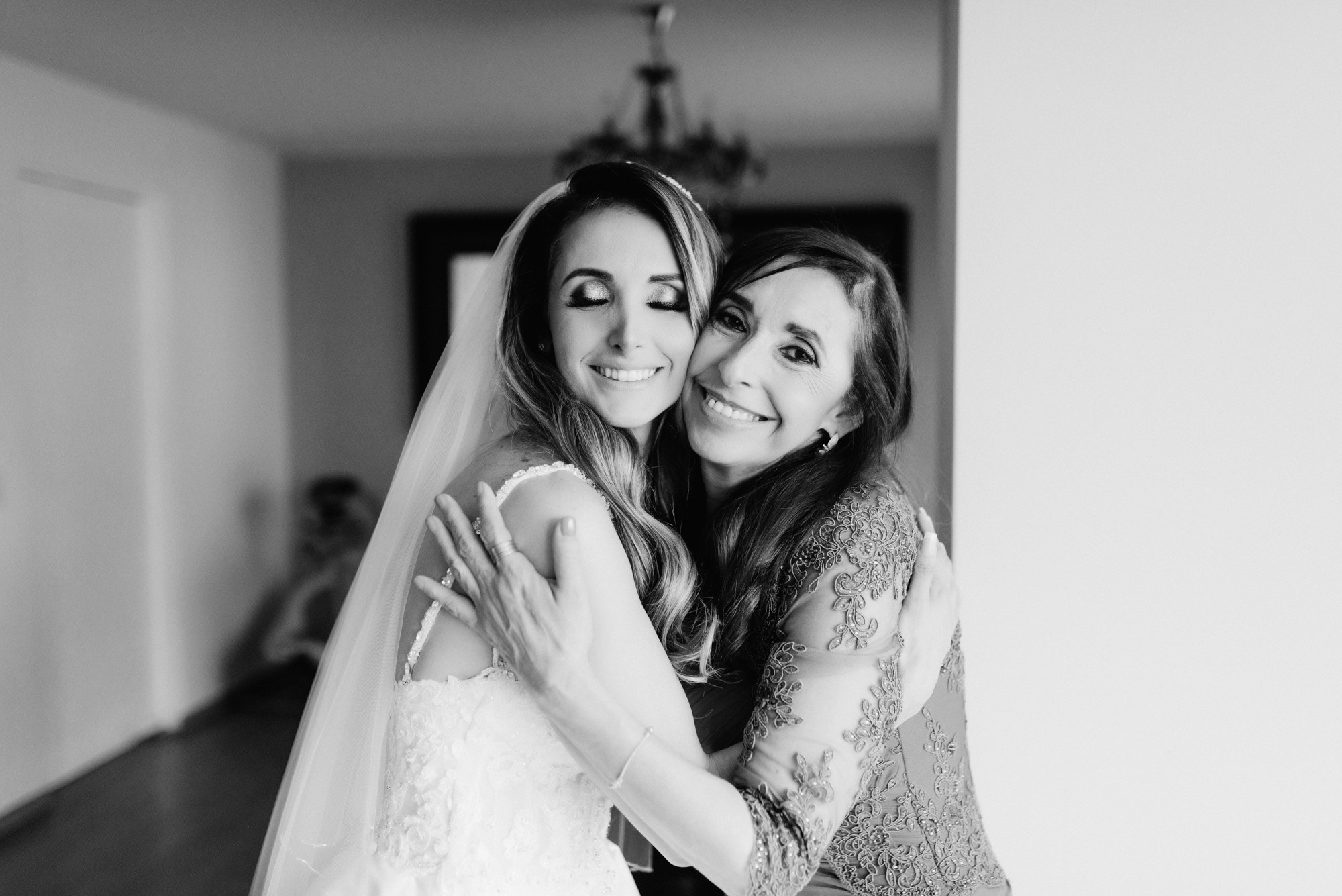 a bride hugging her friend in the hallway