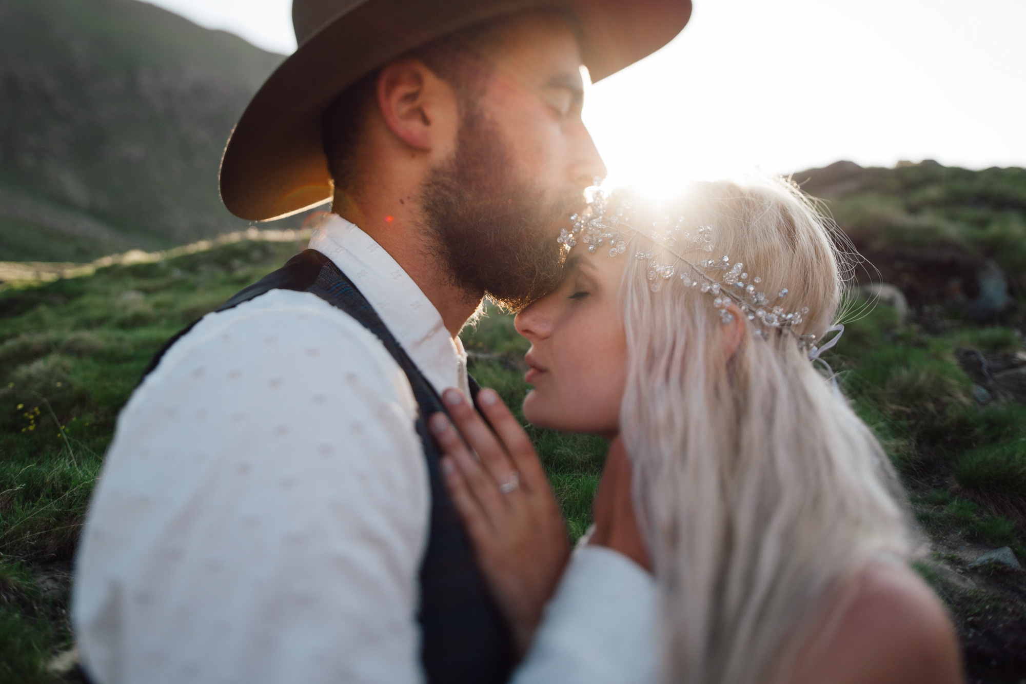a man and woman are kissing in the grass