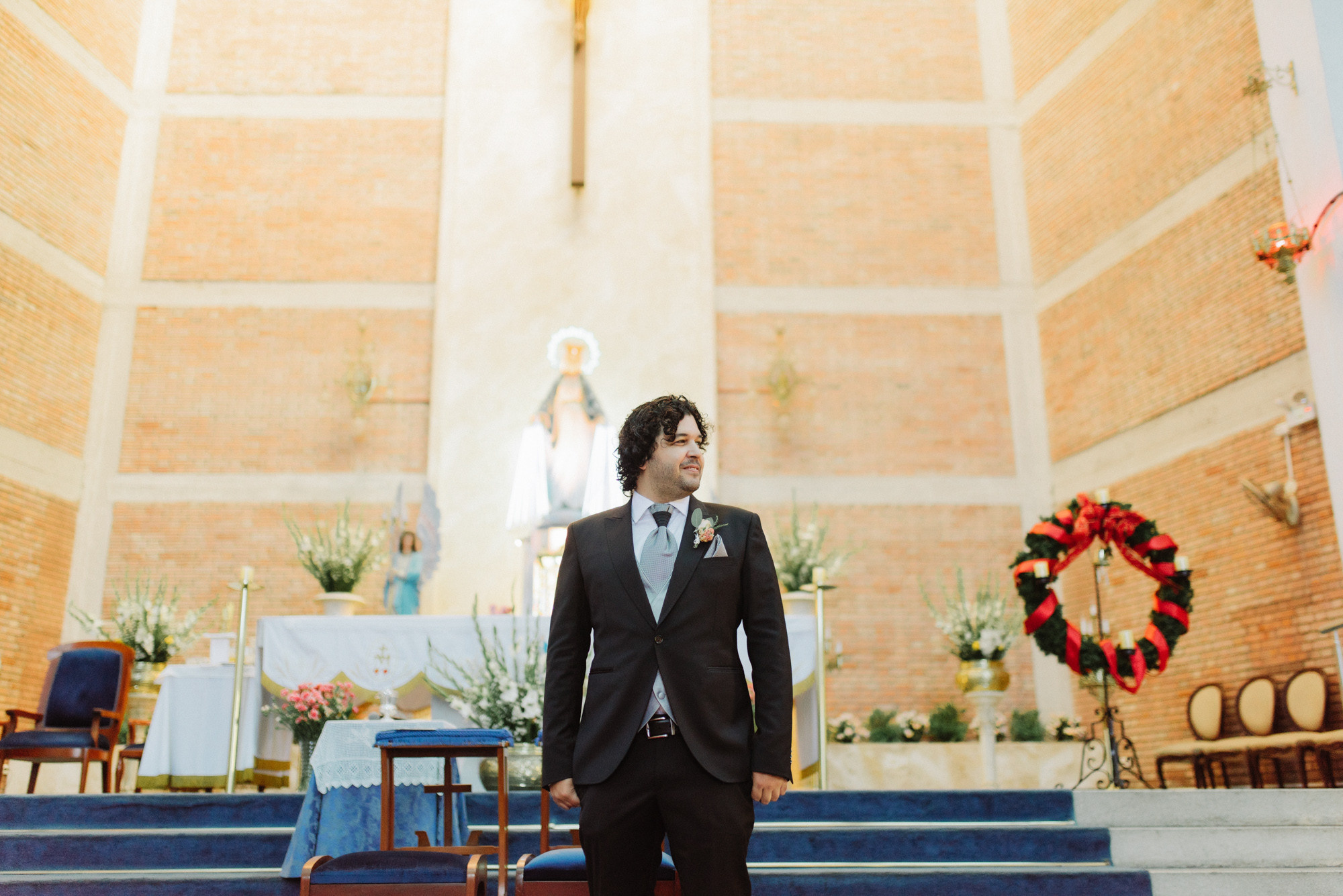a man in a suit standing in front of a church
