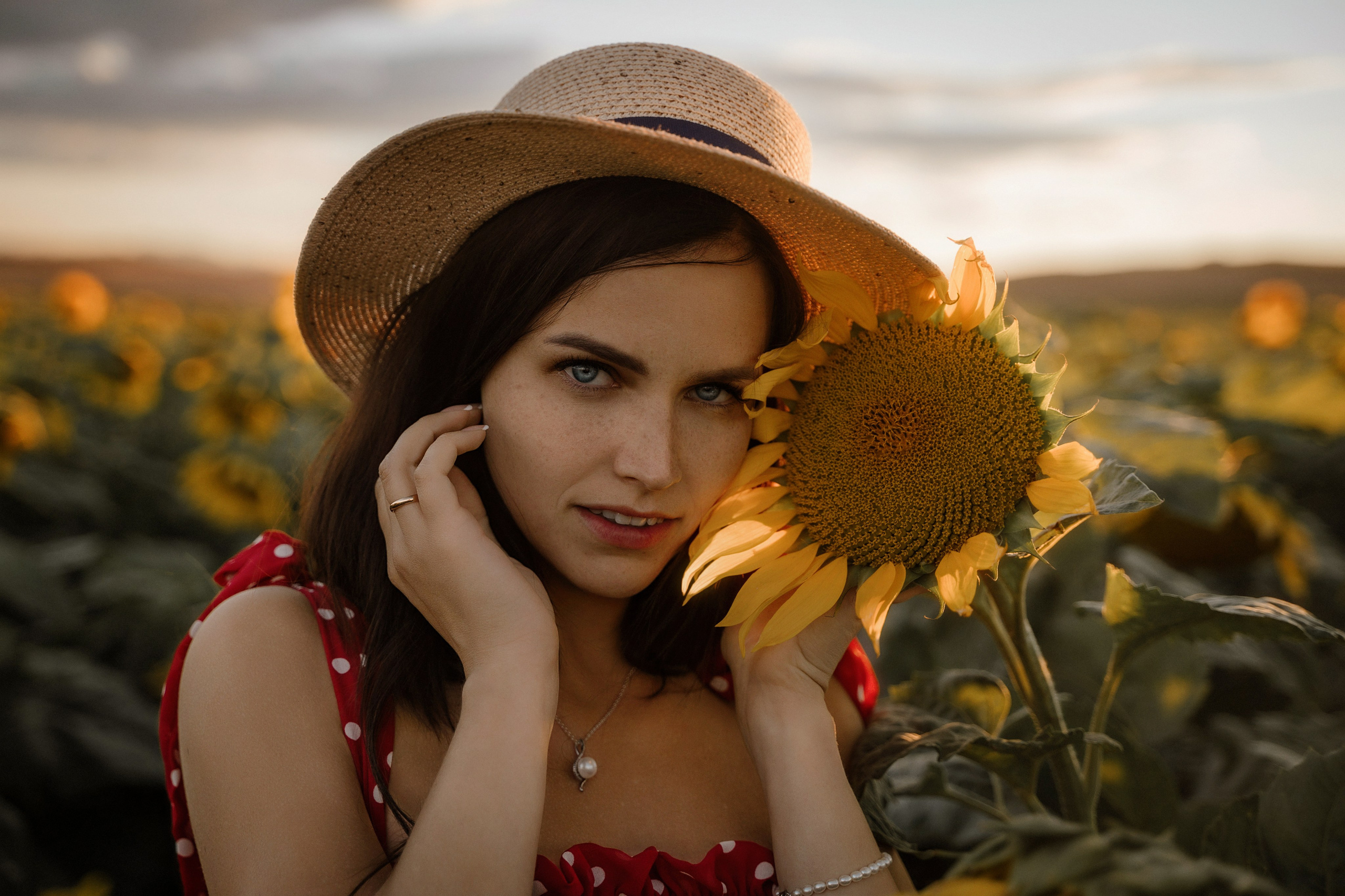 Beautiful model posing at sunset in a sunflower field, captured by Marbella photographer