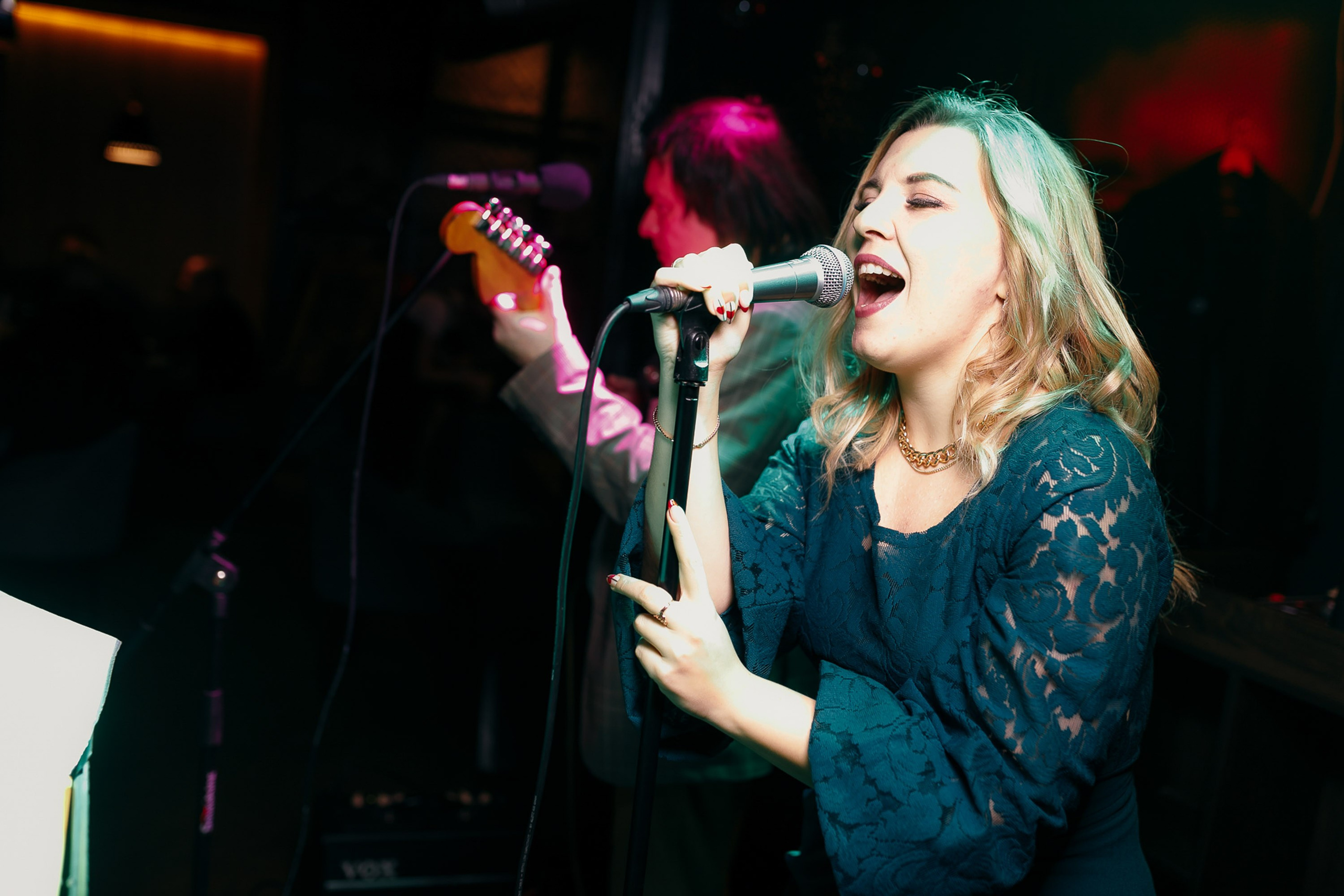 Woman singing at event, lively performance