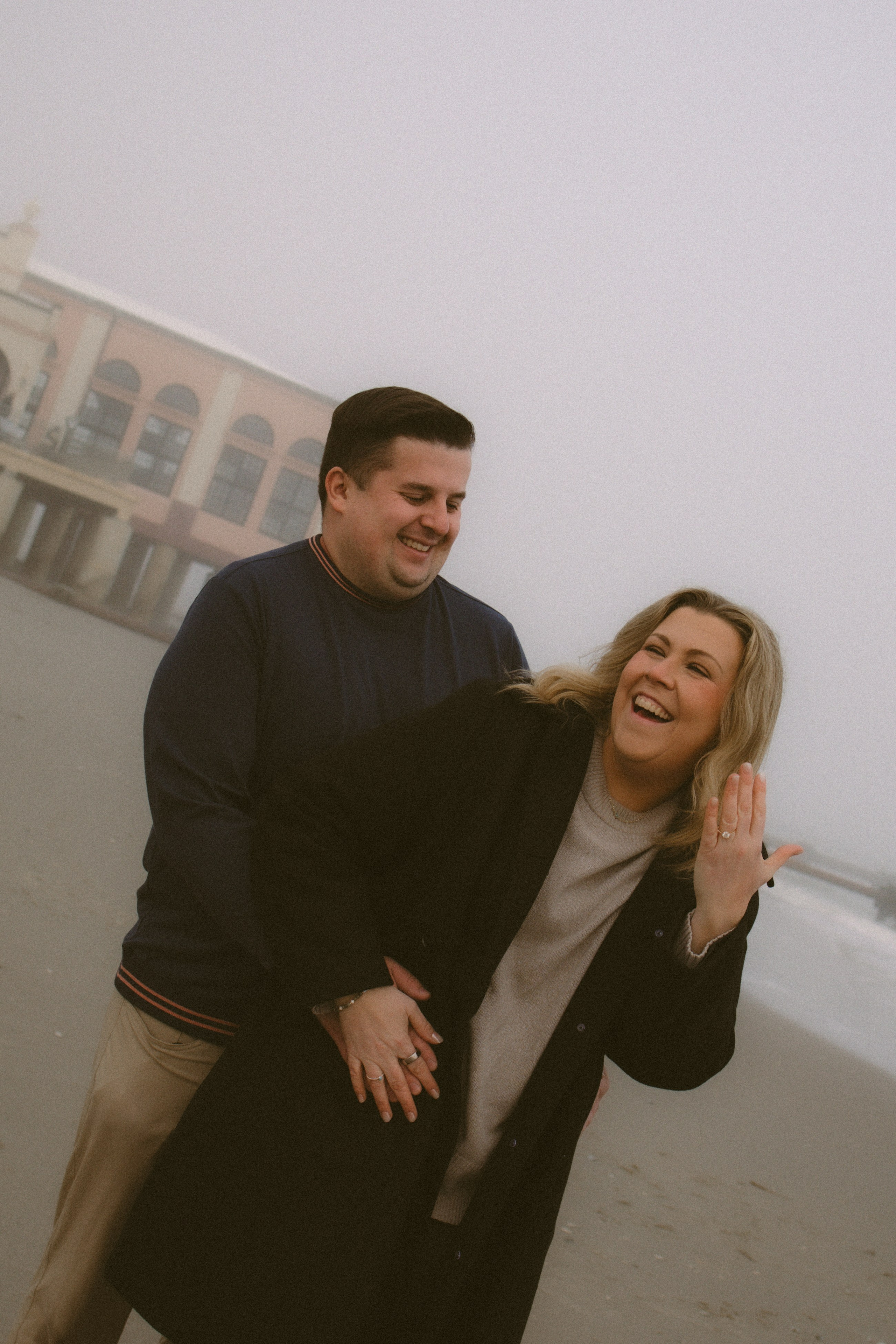 Happy fiancé showing her sparkling engagement ring right after the romantic proposal