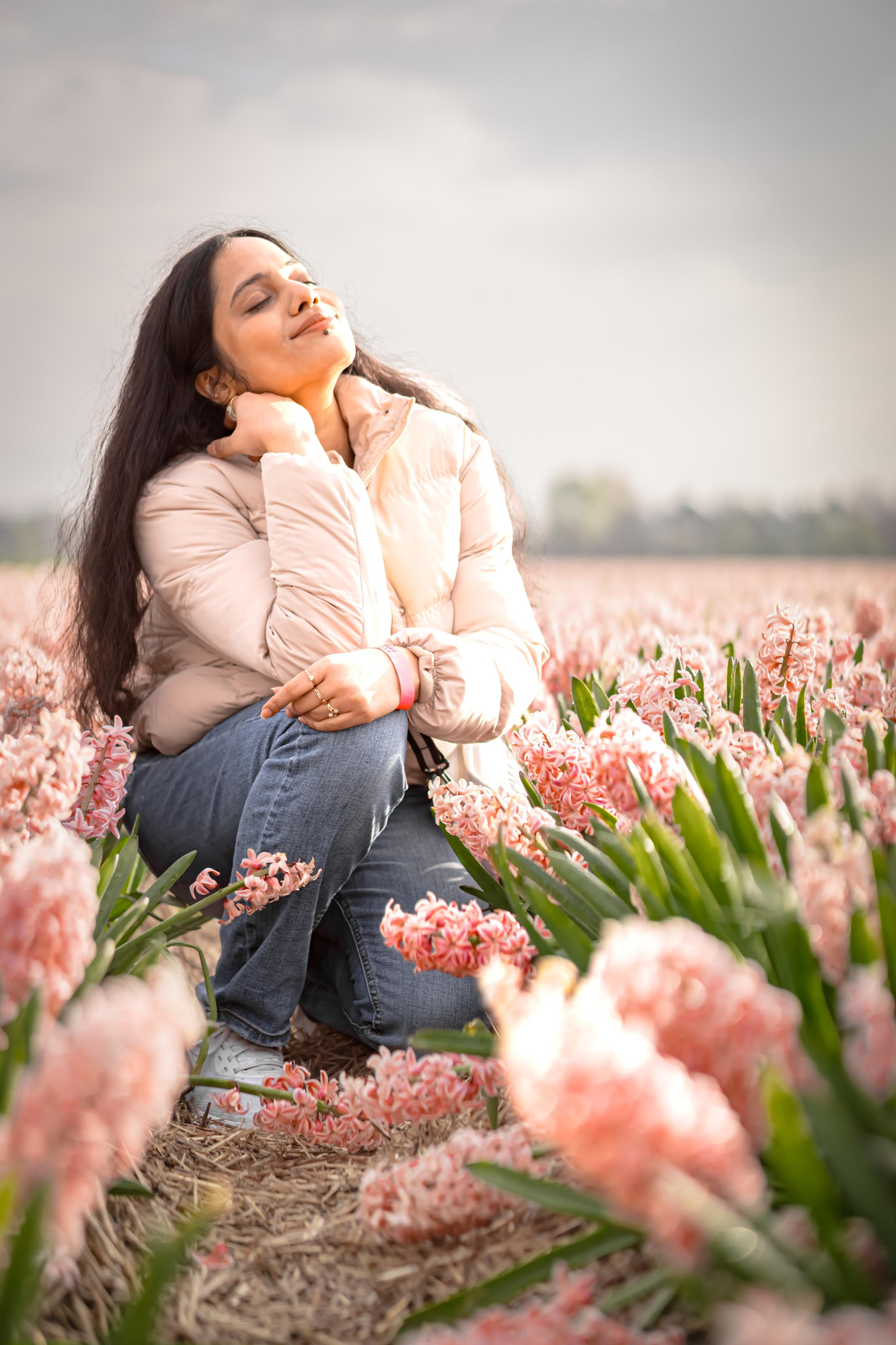 girl sitting in a pink hyacinth fields in Netherlands