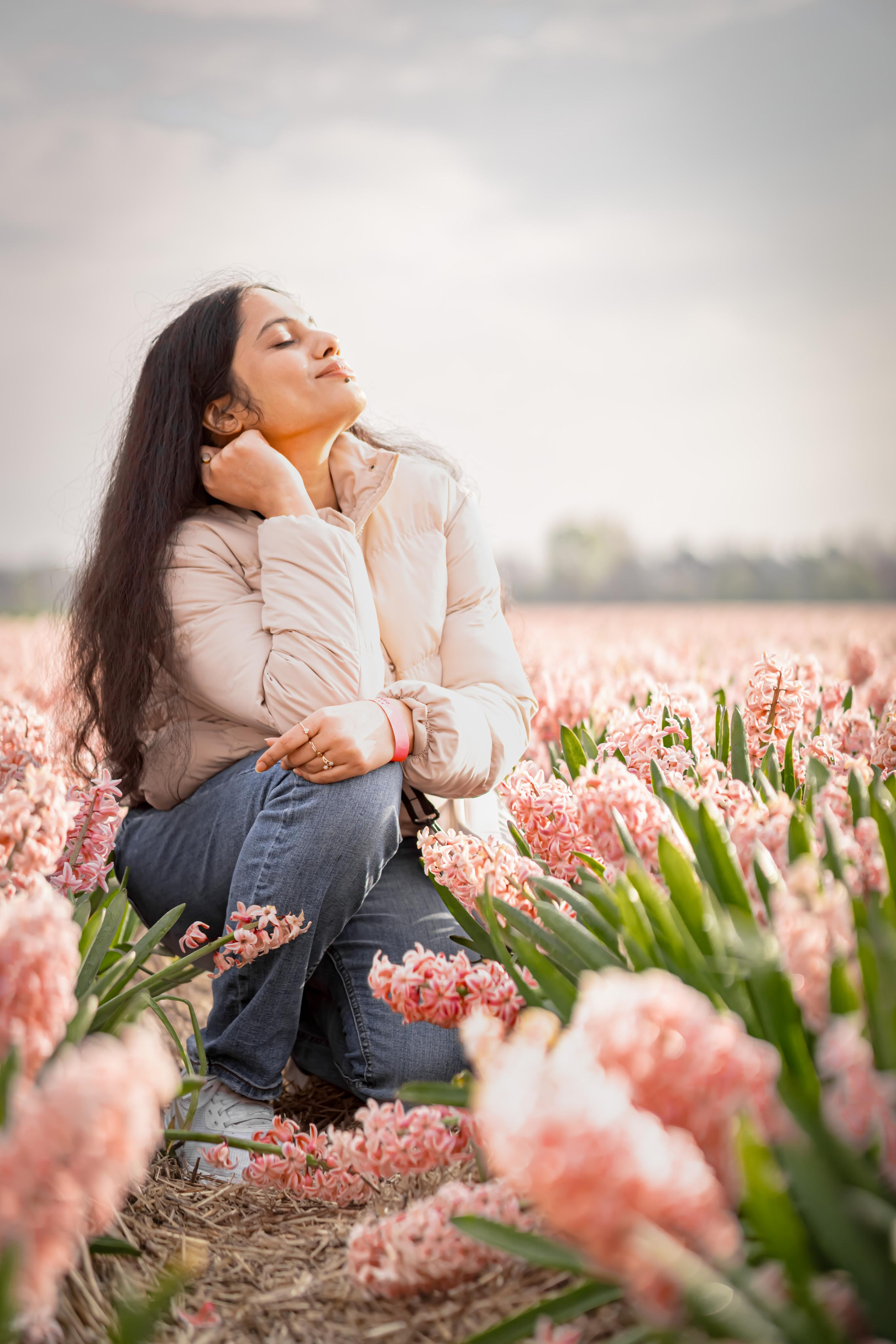 girl sitting in a pink hyacinth fields in Netherlands
