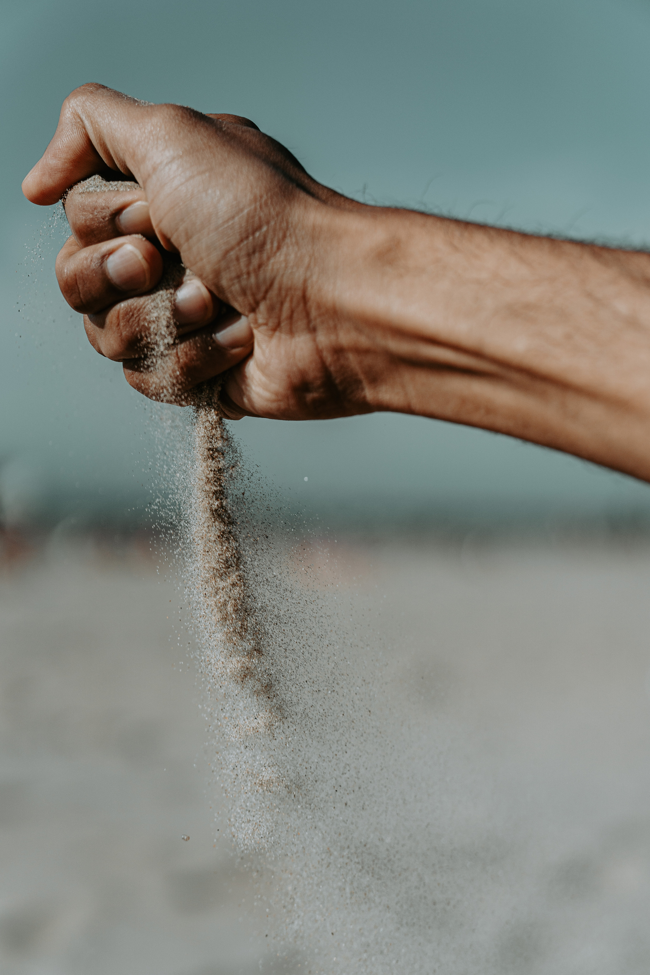 sand slipping from hand
