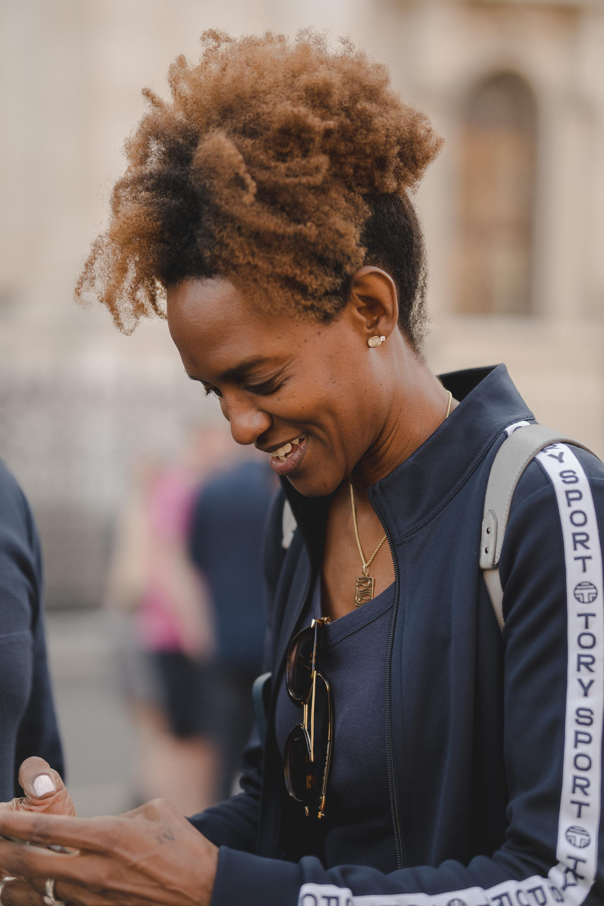 A woman smiling looking at her mobile