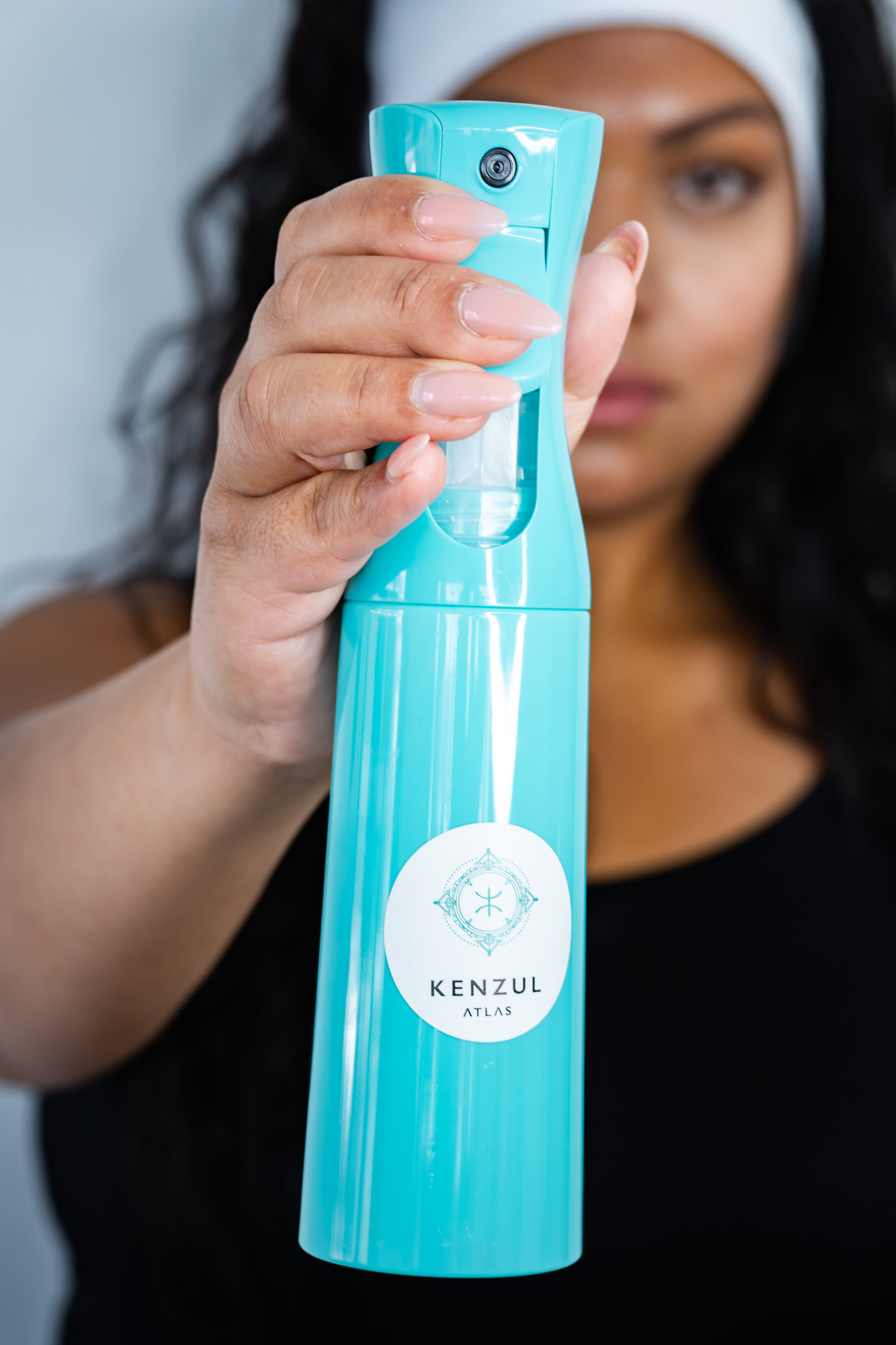 girl holding a blue spray bottle