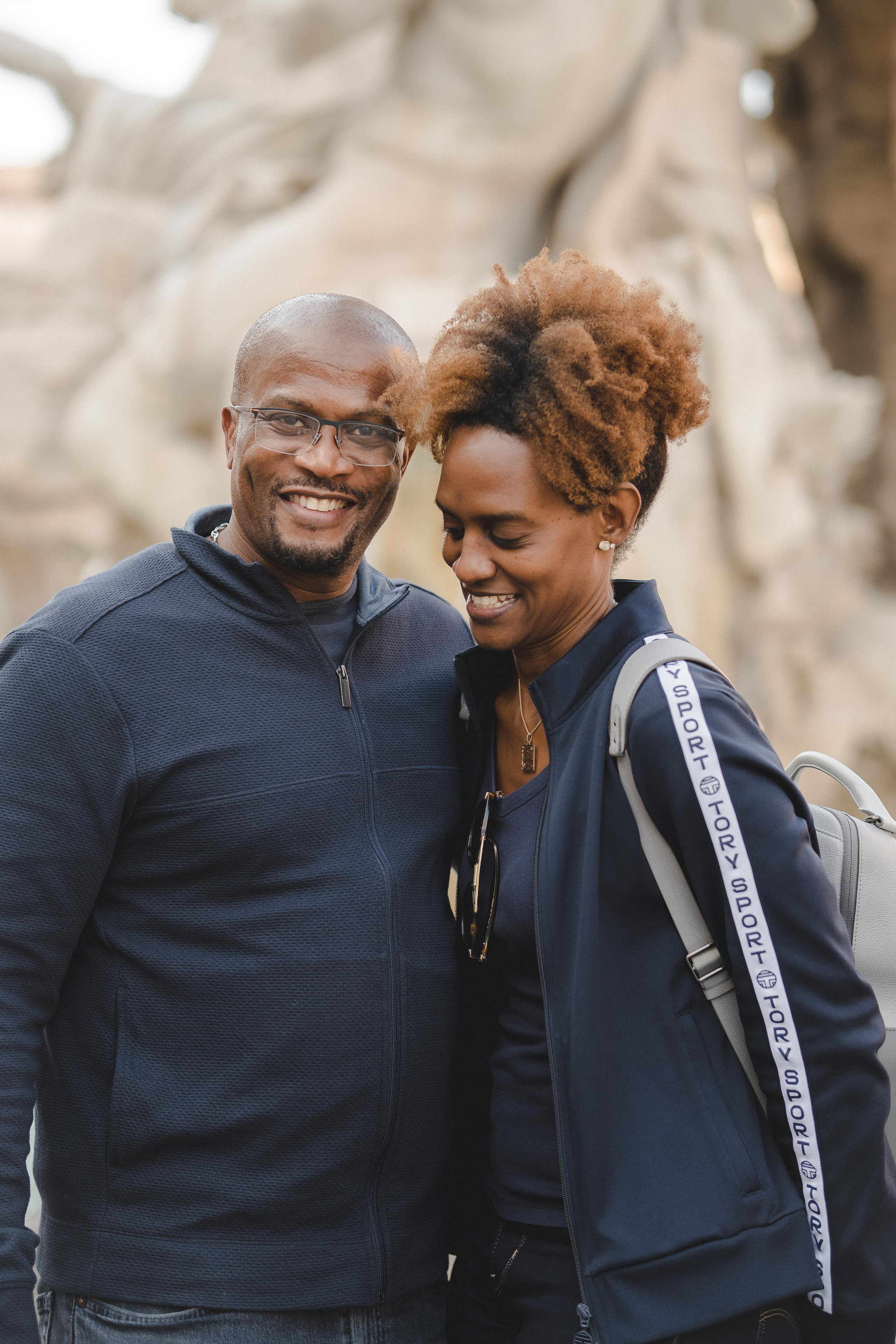 A black couple laughing with each other in Rome