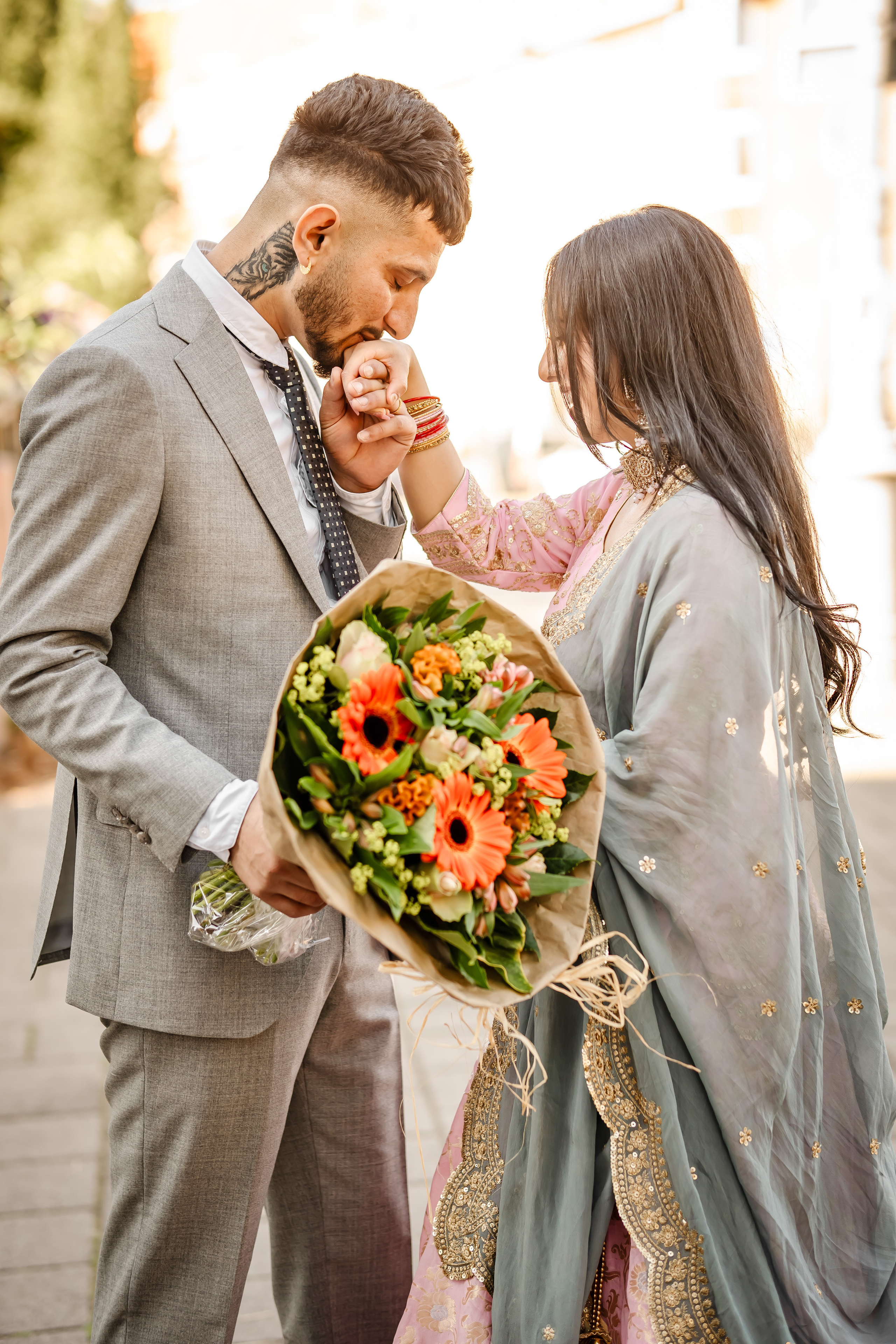 a man kissing the hand of his wife