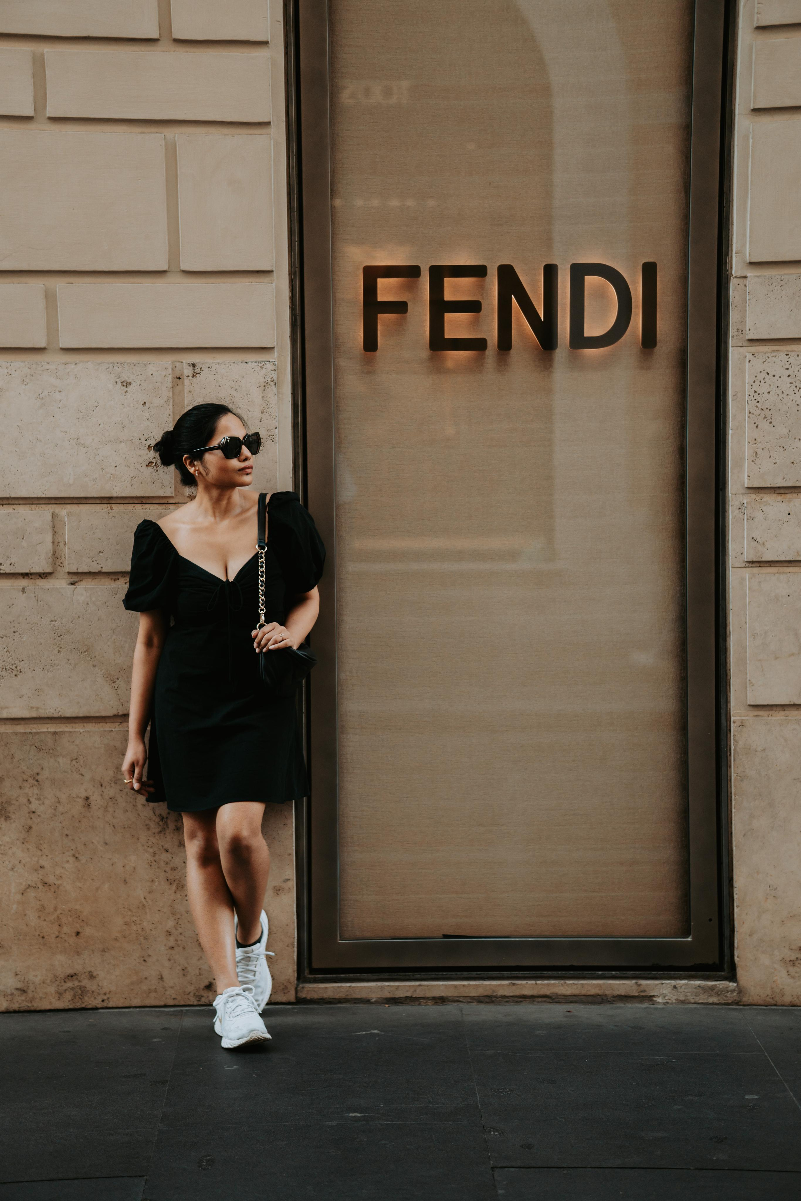 a woman standing near fendi store in rome