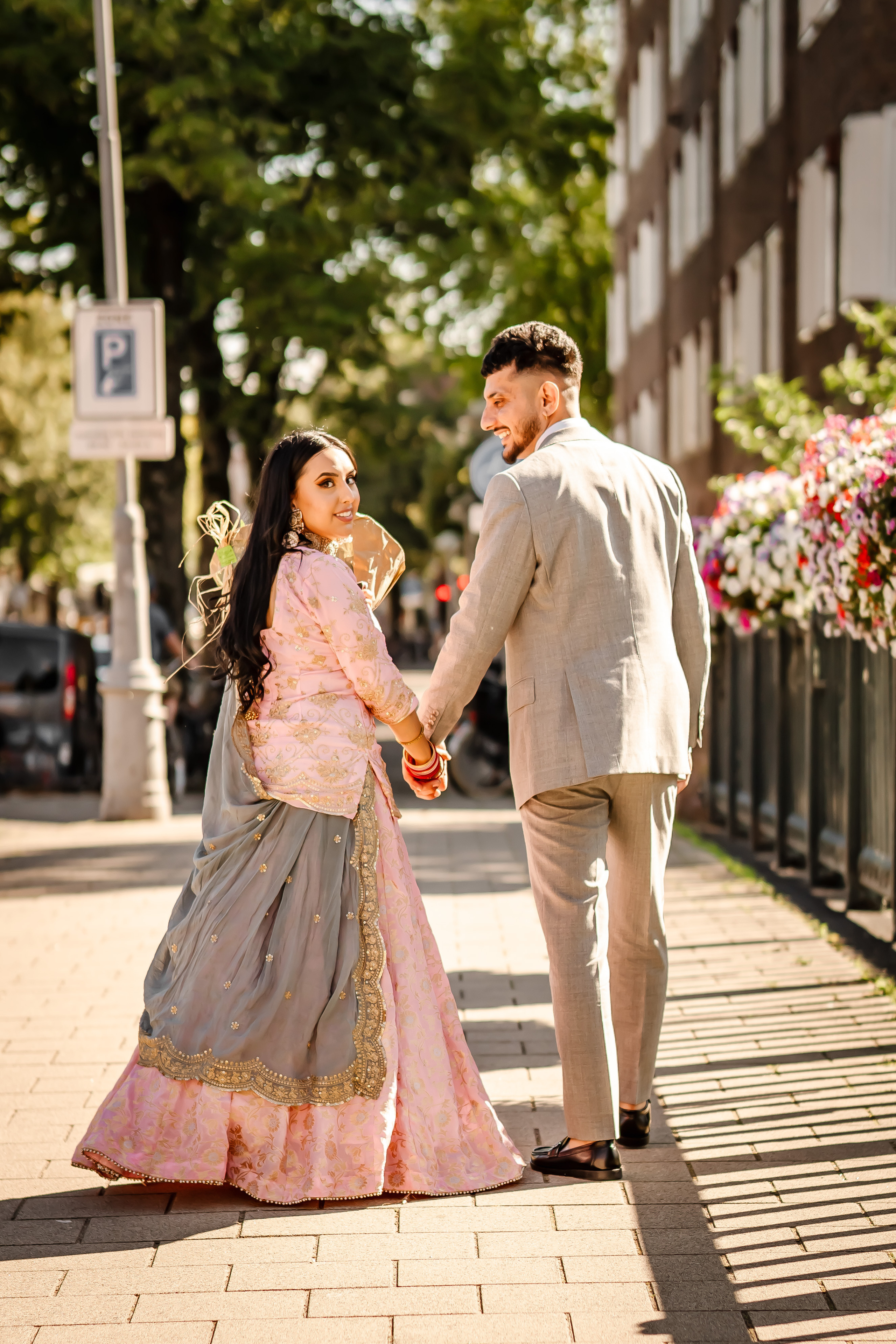 a man and his fiancee walking hand in hand in amsterdam