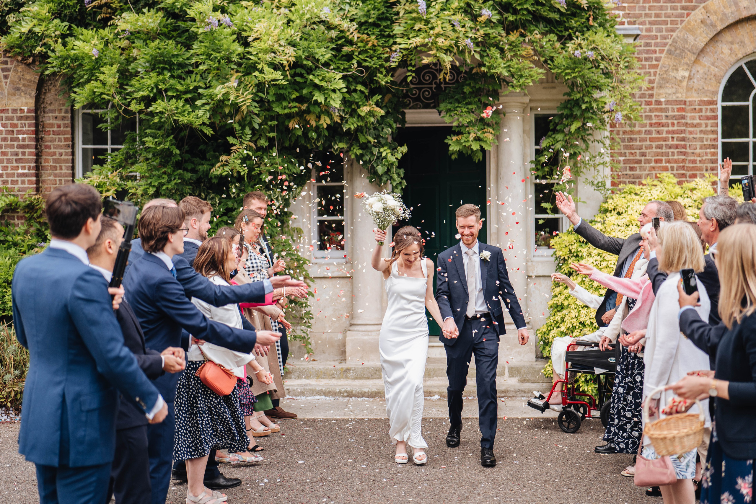 bride and groom happy to see confetti after the ceremony 