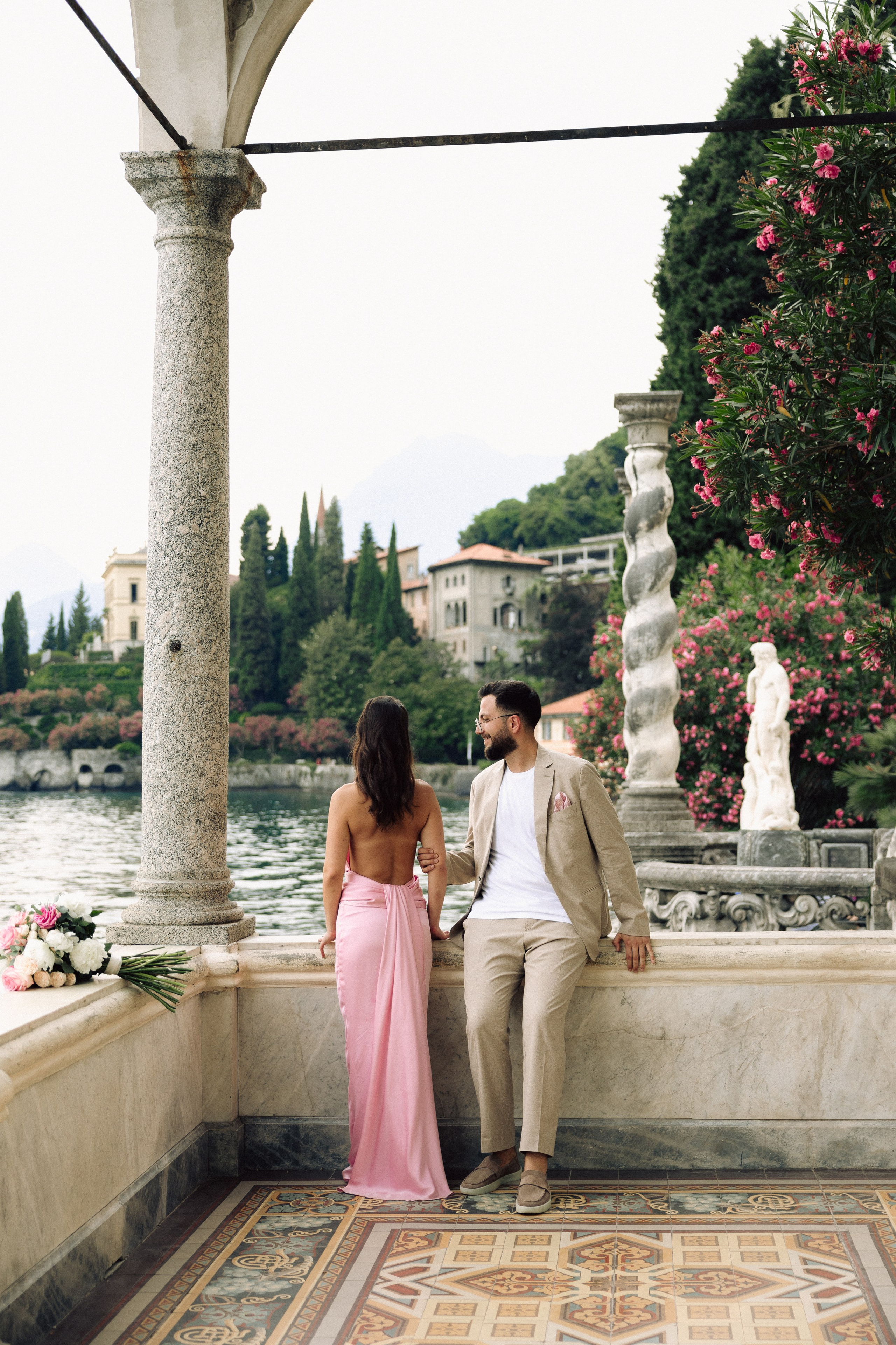 Couple celebrating a surprise marriage proposal at Villa Monastero, Lake Como