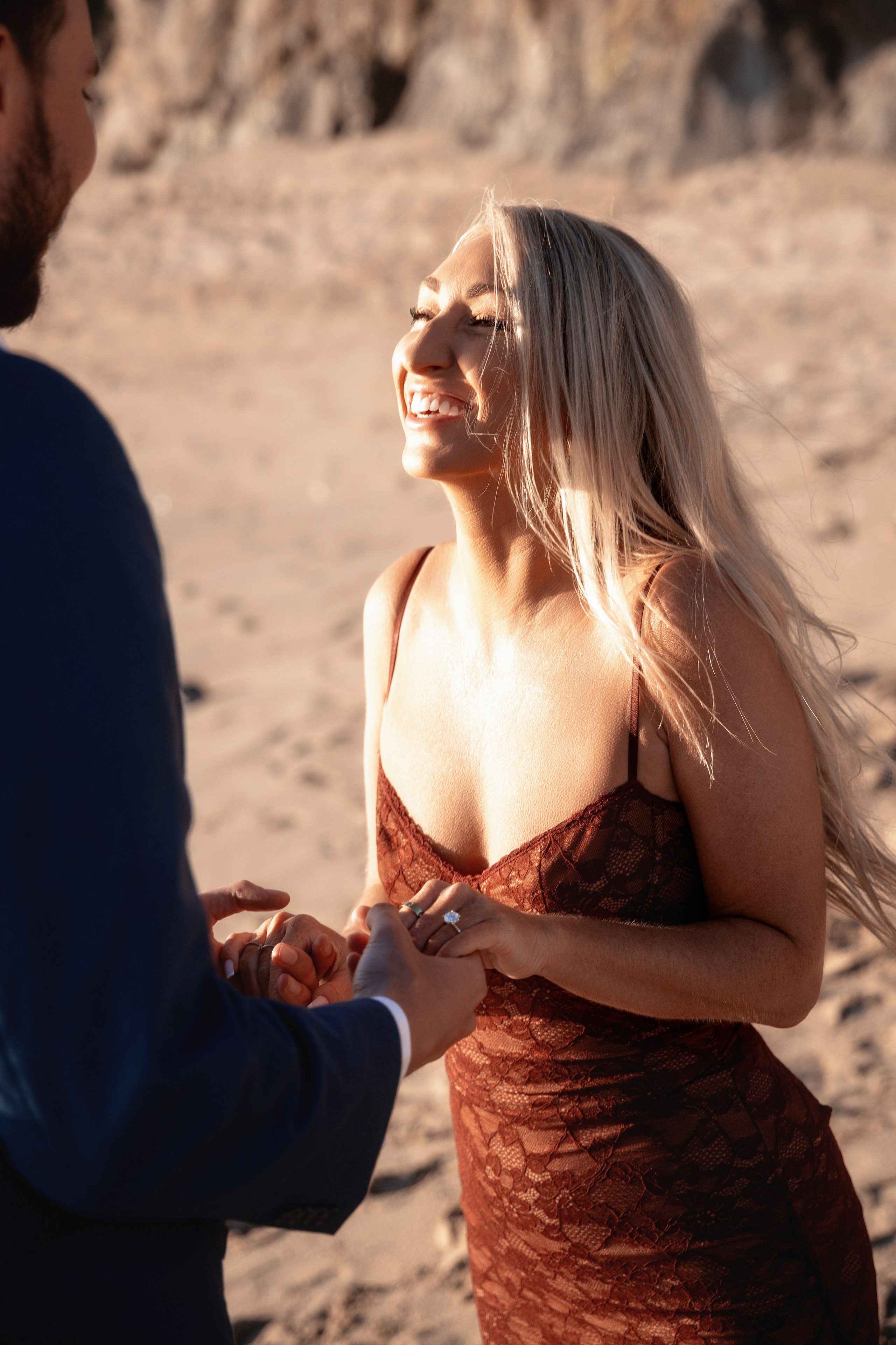 Couple holding hands with Bay Area bridges in the background after the proposal