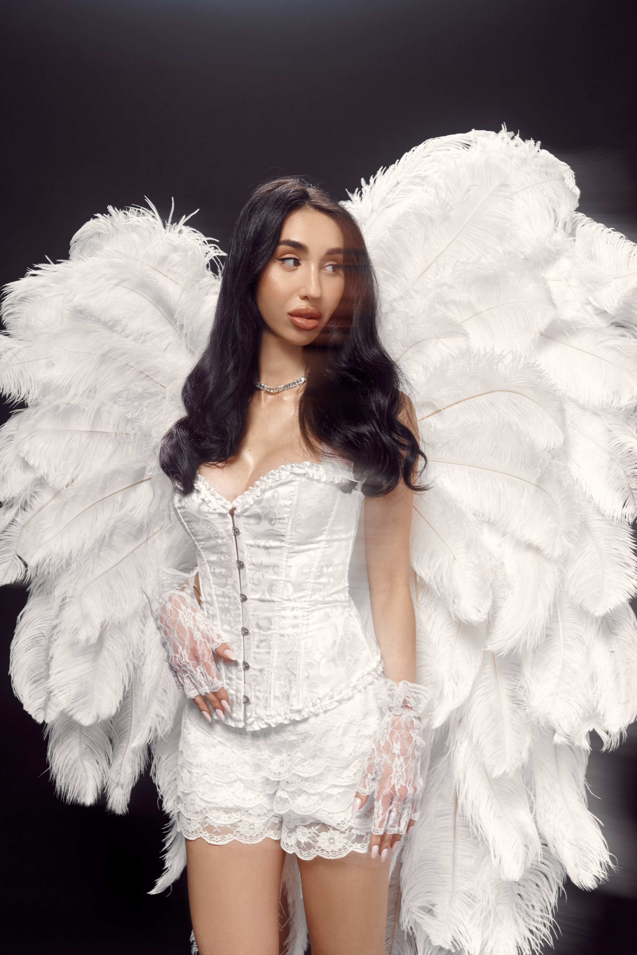 Artistic studio portrait of Ester Rogovaya with wings, blur effect and contemporary fashion styling