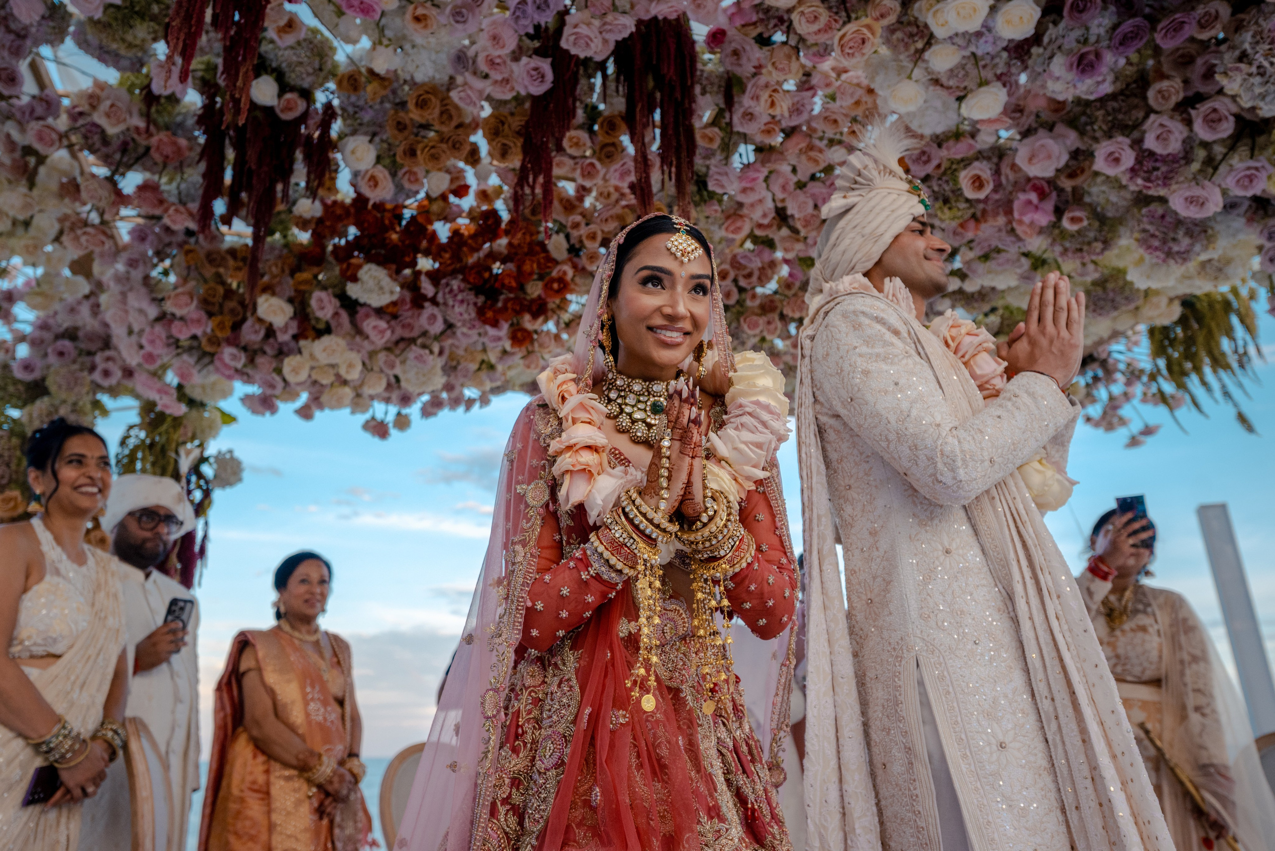 Indian bride and groom greeting wedding guests with hands together after the ceremony in Cancun destination wedding