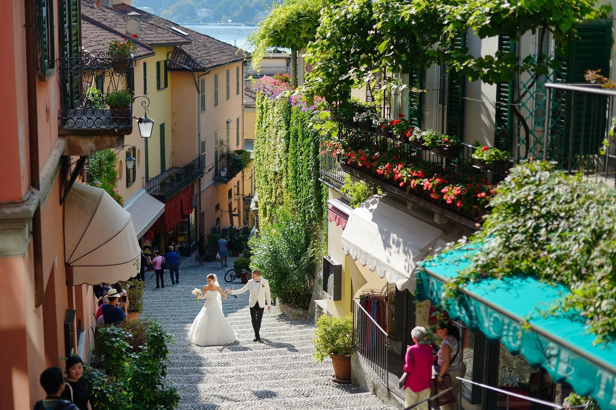 Bride and groom walking Bellagio Lake Como