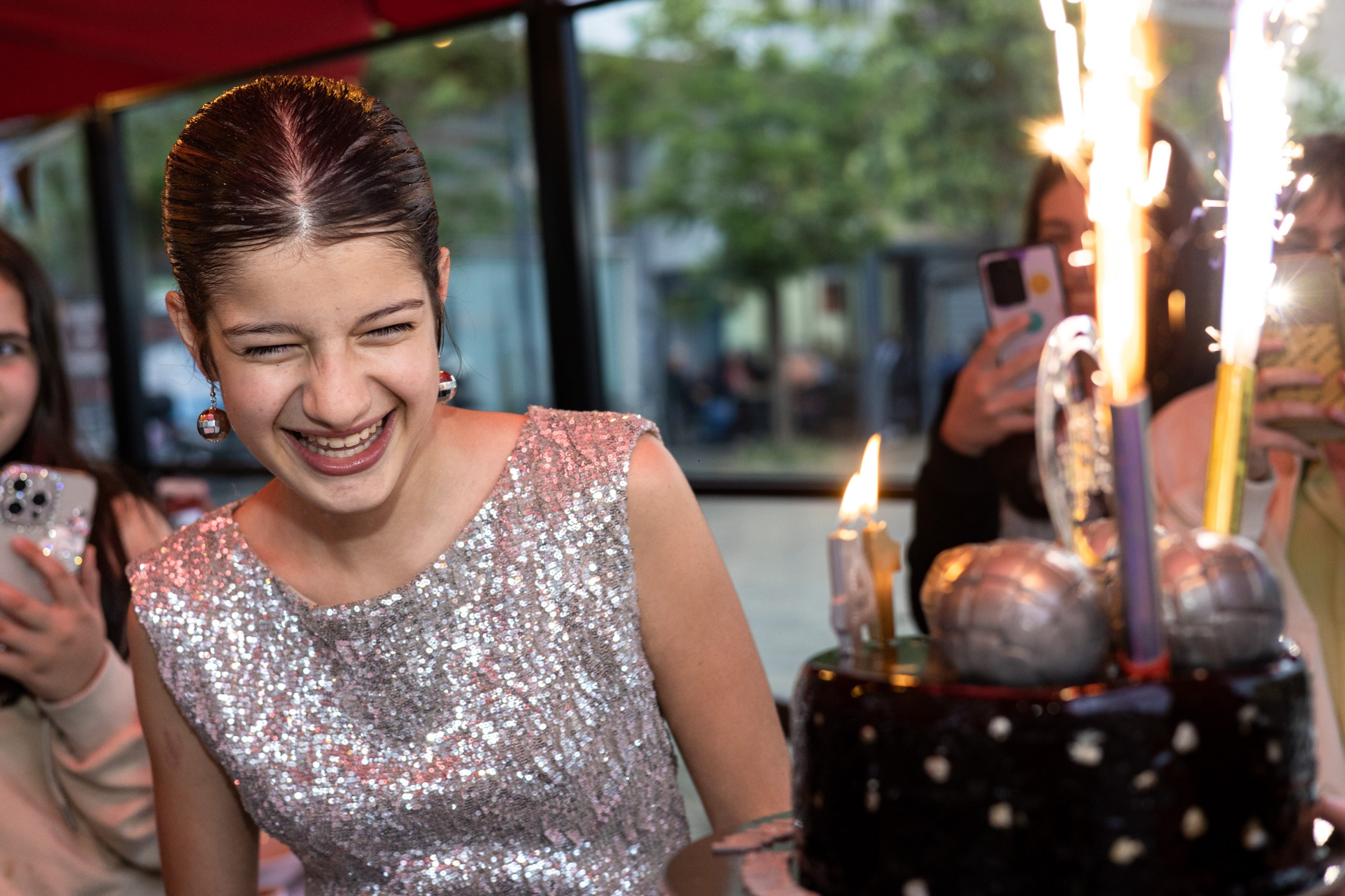 Birthday girl blowing out the candles on her cake