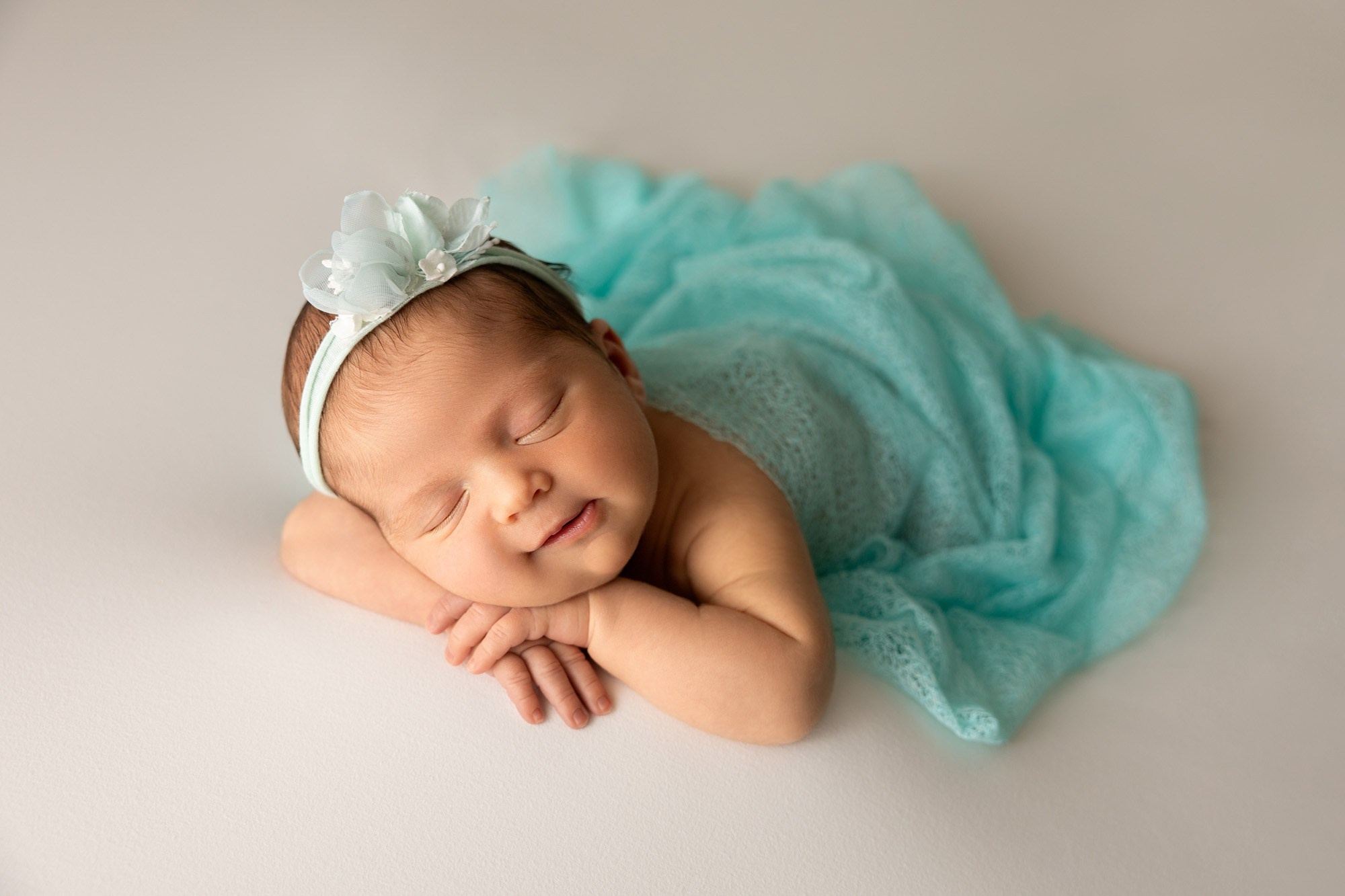 newborn sleeping chin on hands