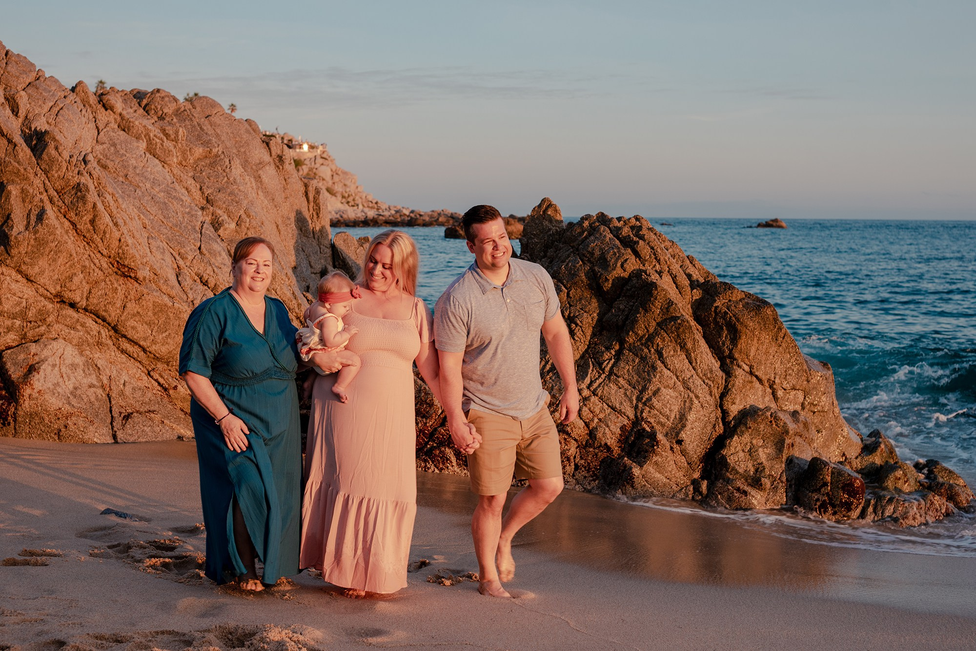 Grandmother mother father and baby during multi-generational vacation photo session on Playa Monumentos Cabo San Lucas