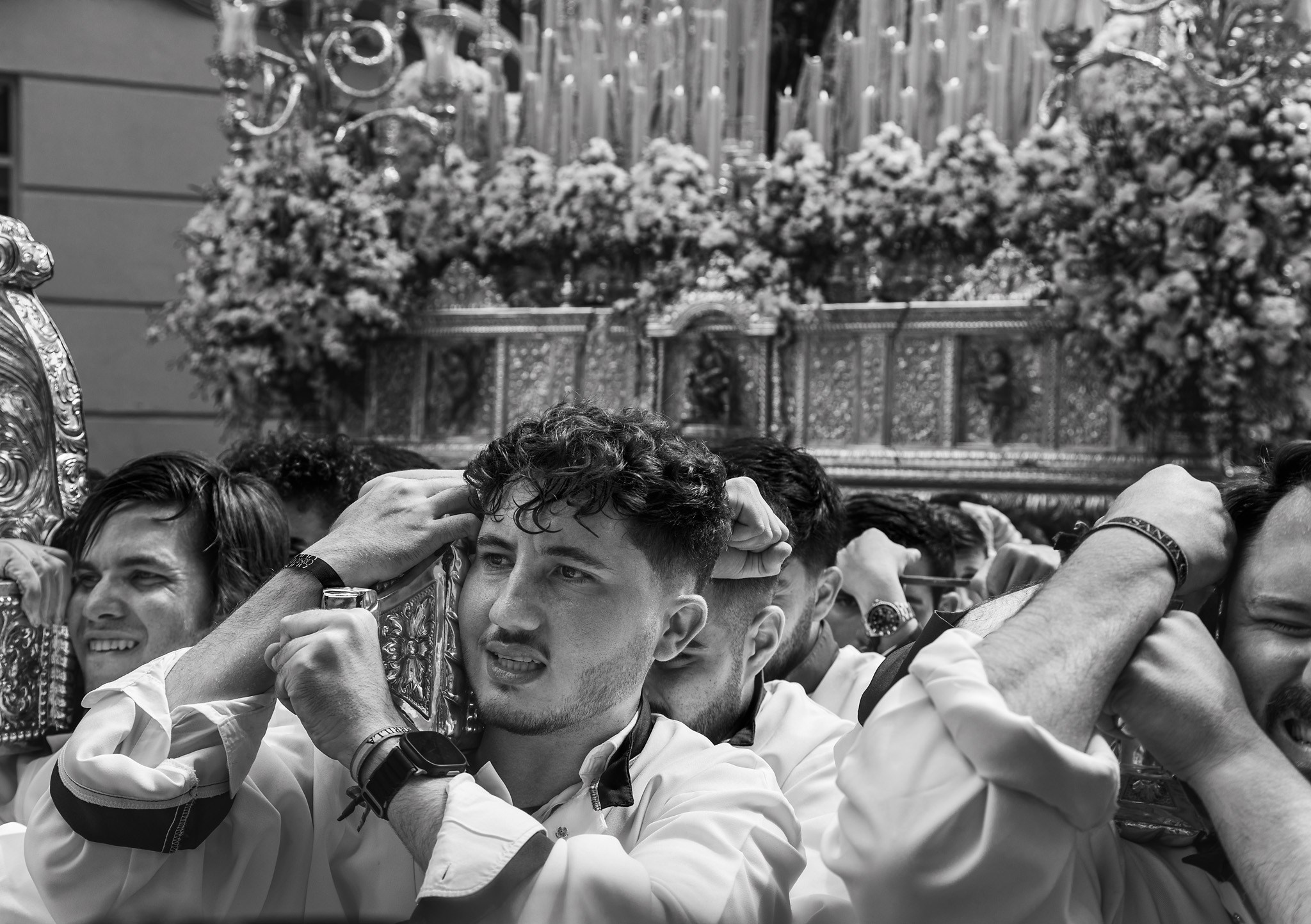 Costaleros carrying heavy paso during Semana Santa in Spain