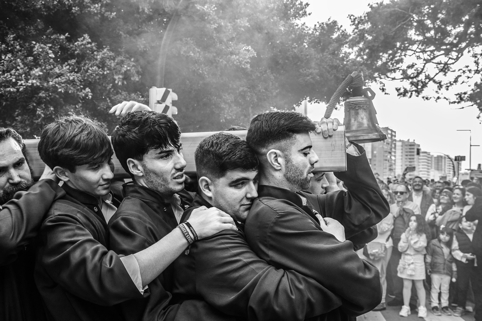 Costaleros carrying heavy religious float during Semana Santa in Malaga, Spain