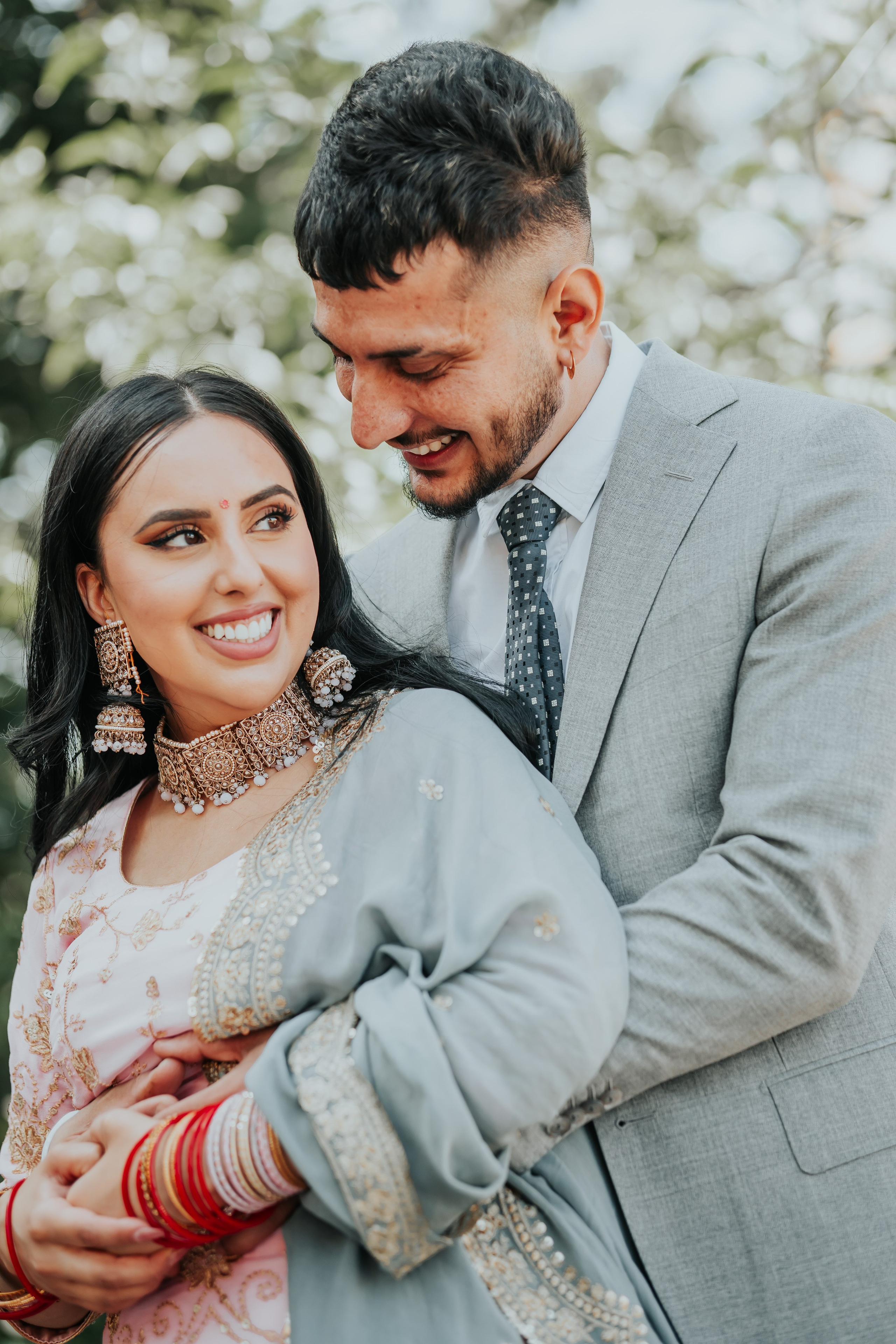 a man holdin the bride from behind