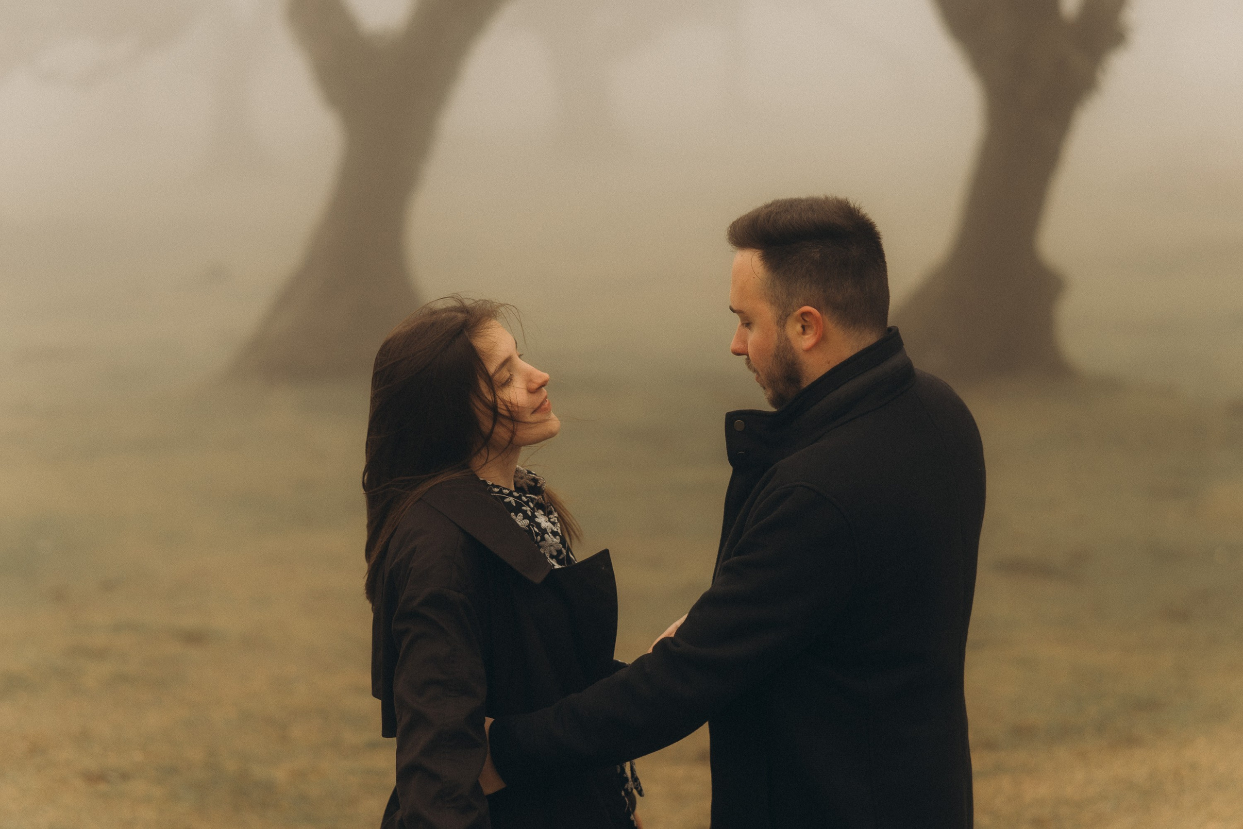 Couple photoshoot in Fanal Forest Madeira PortugalA romantic couple standing amidst the ancient laurel trees of Fanal Forest, Madeira, surrounded by a mystical fog that adds an ethereal touch to the scene