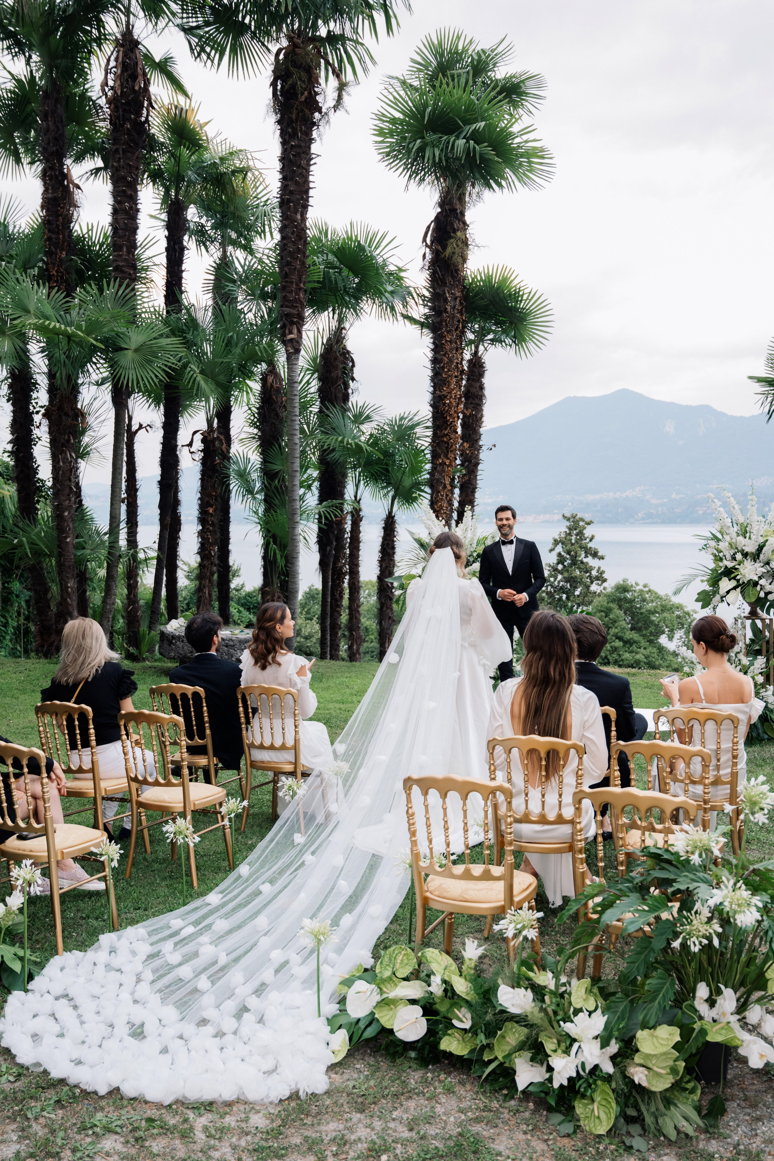 a wedding ceremony with palm trees and chairs
