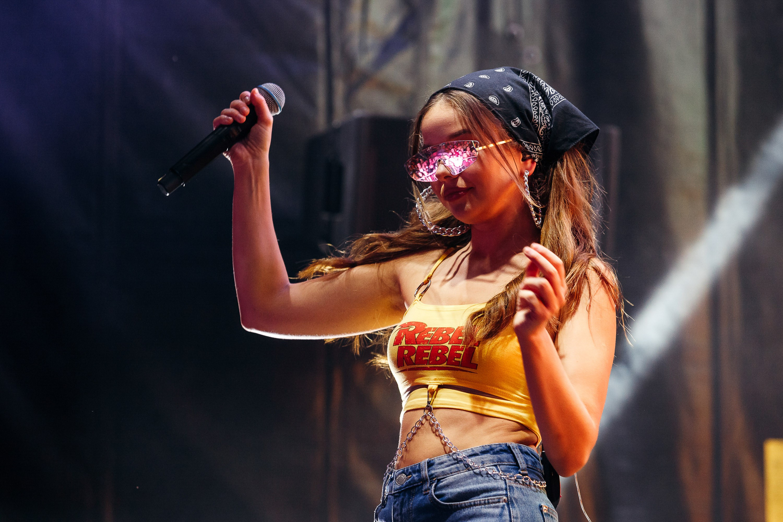 Female singer in gold outfit performing on stage