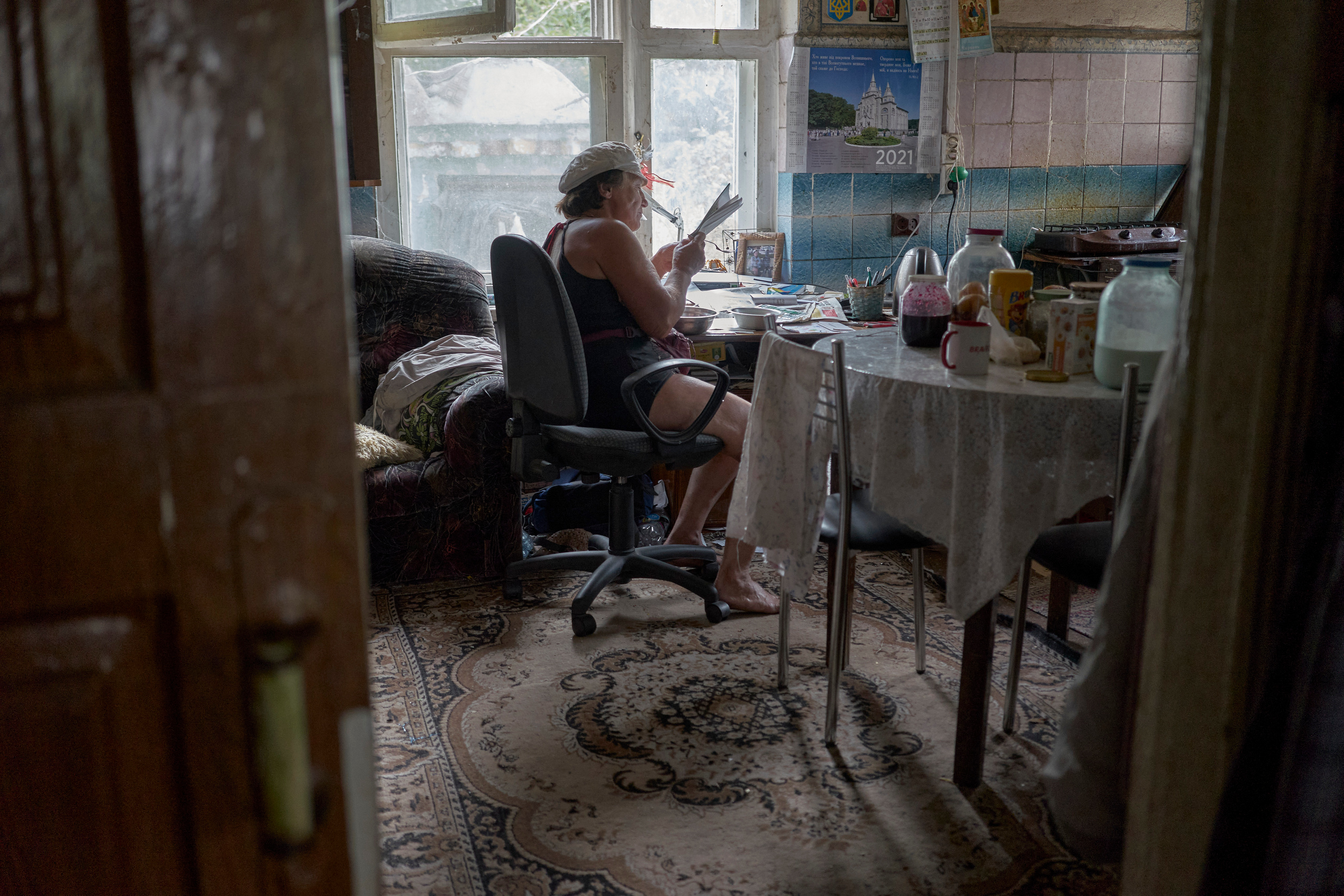 Natalia Dmitrievna is reading a book while having lunch during the break after work.