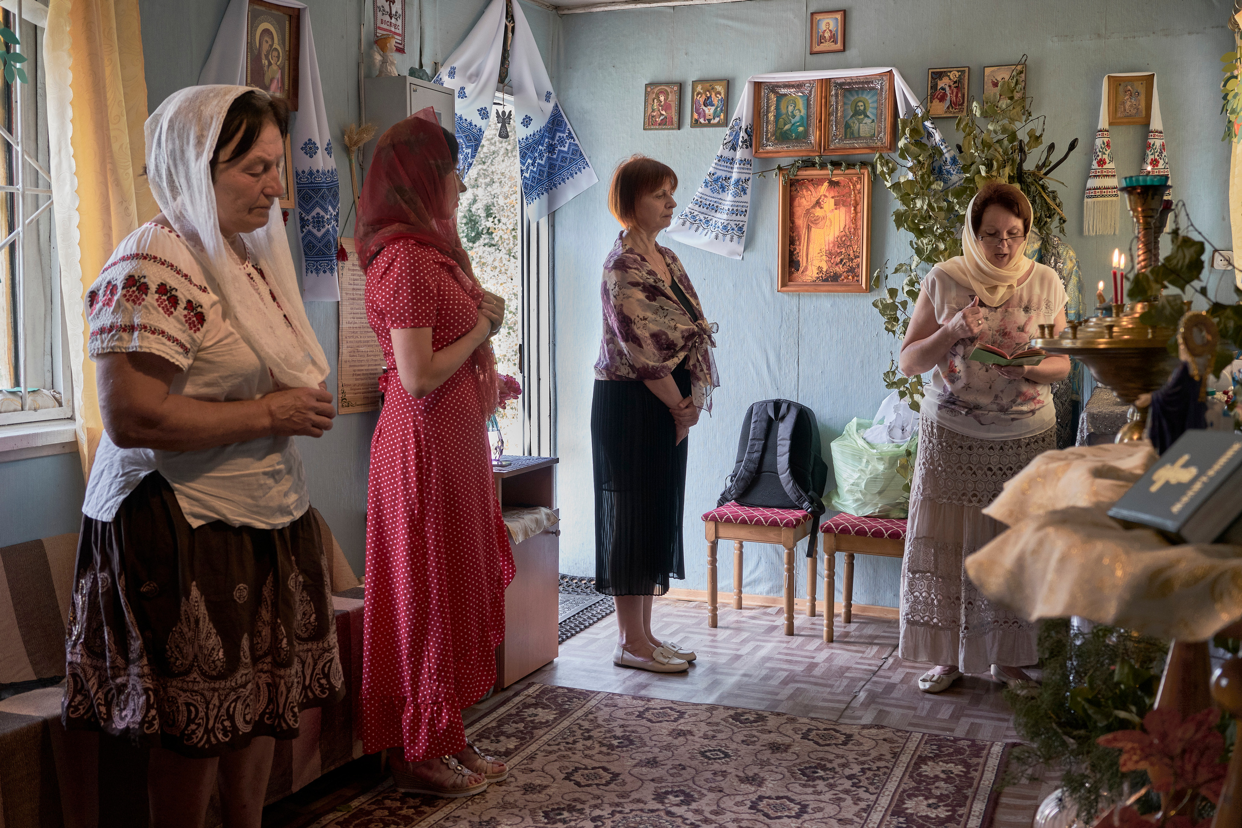 Natalia Dmitrievna with other parishioners at the Sunday church service in the small chapel near her house.