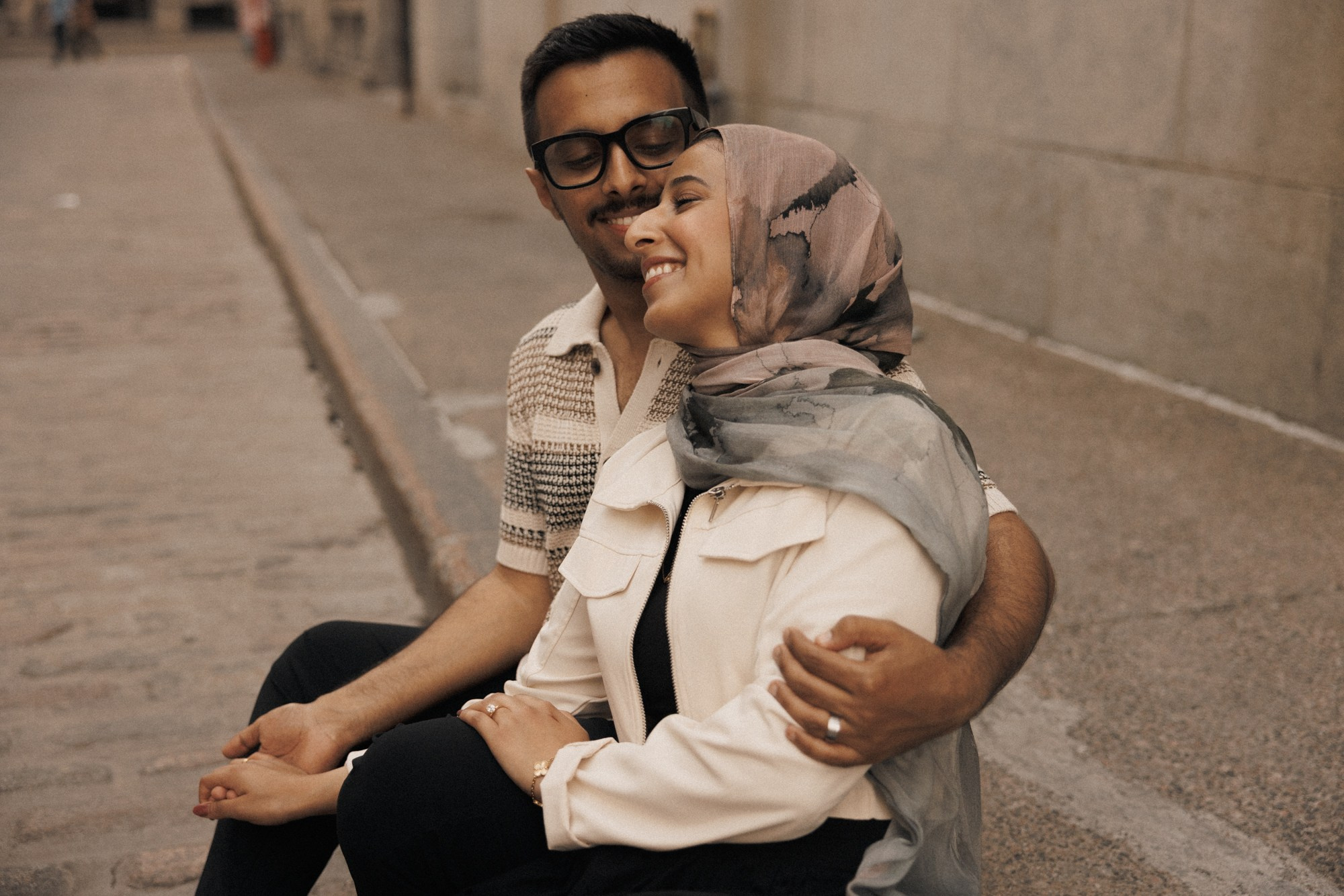 Romantic couple sitting together on quiet Montreal street