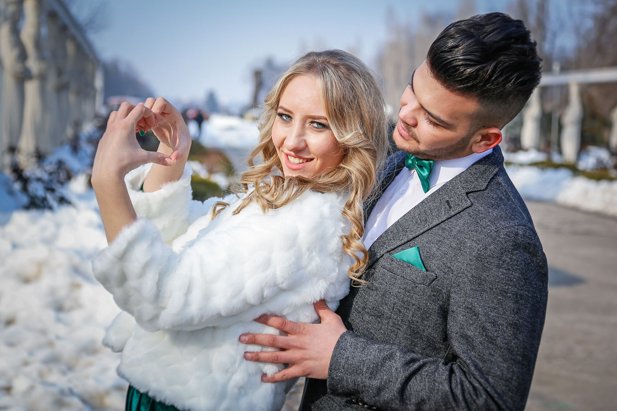 Intimate close-up shot of the newlyweds with their foreheads touching, expressing love and connection in the winter setting.