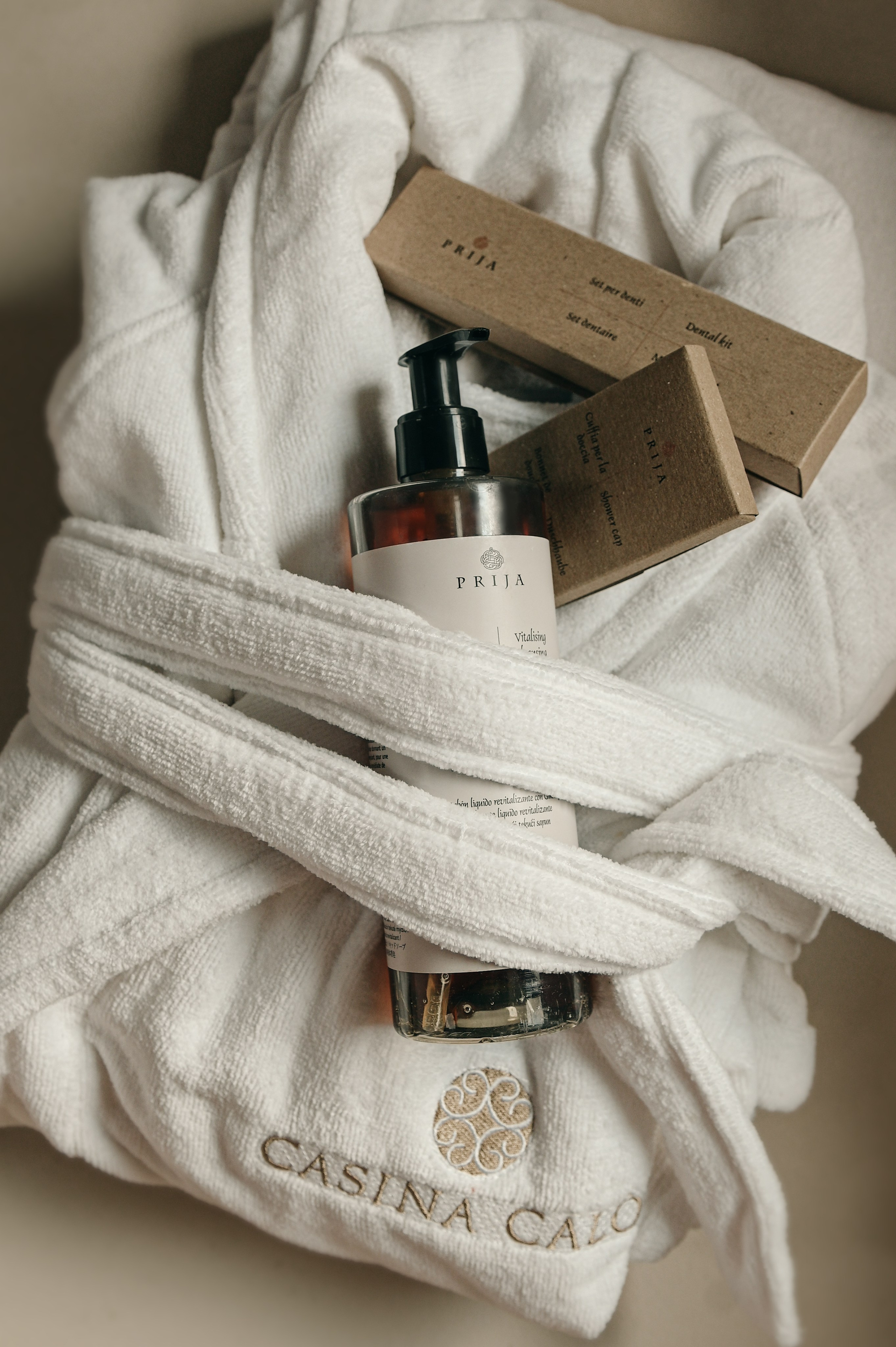 Luxury hotel bathrobe with organic guest amenities and natural toiletries, photographed at boutique