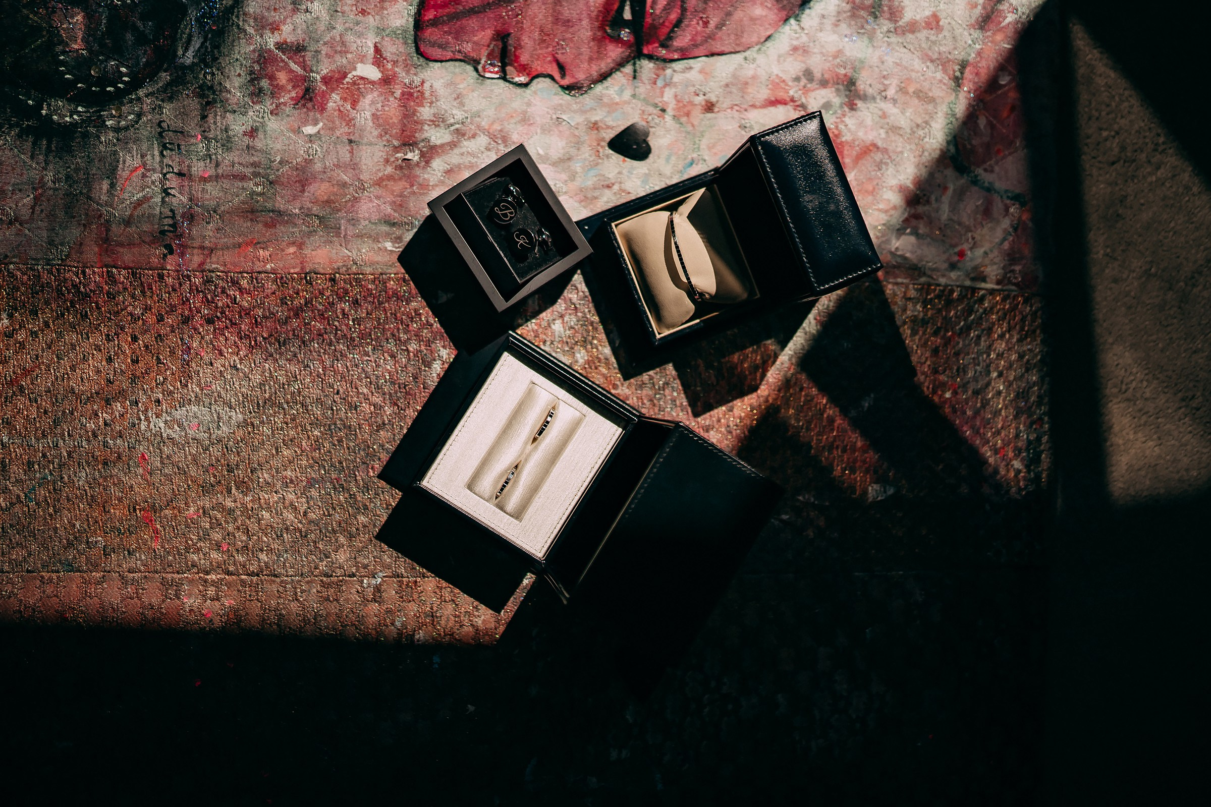 Wedding rings in the black jewelry box highlighted with sun in a unique celebratory atmosphere. 