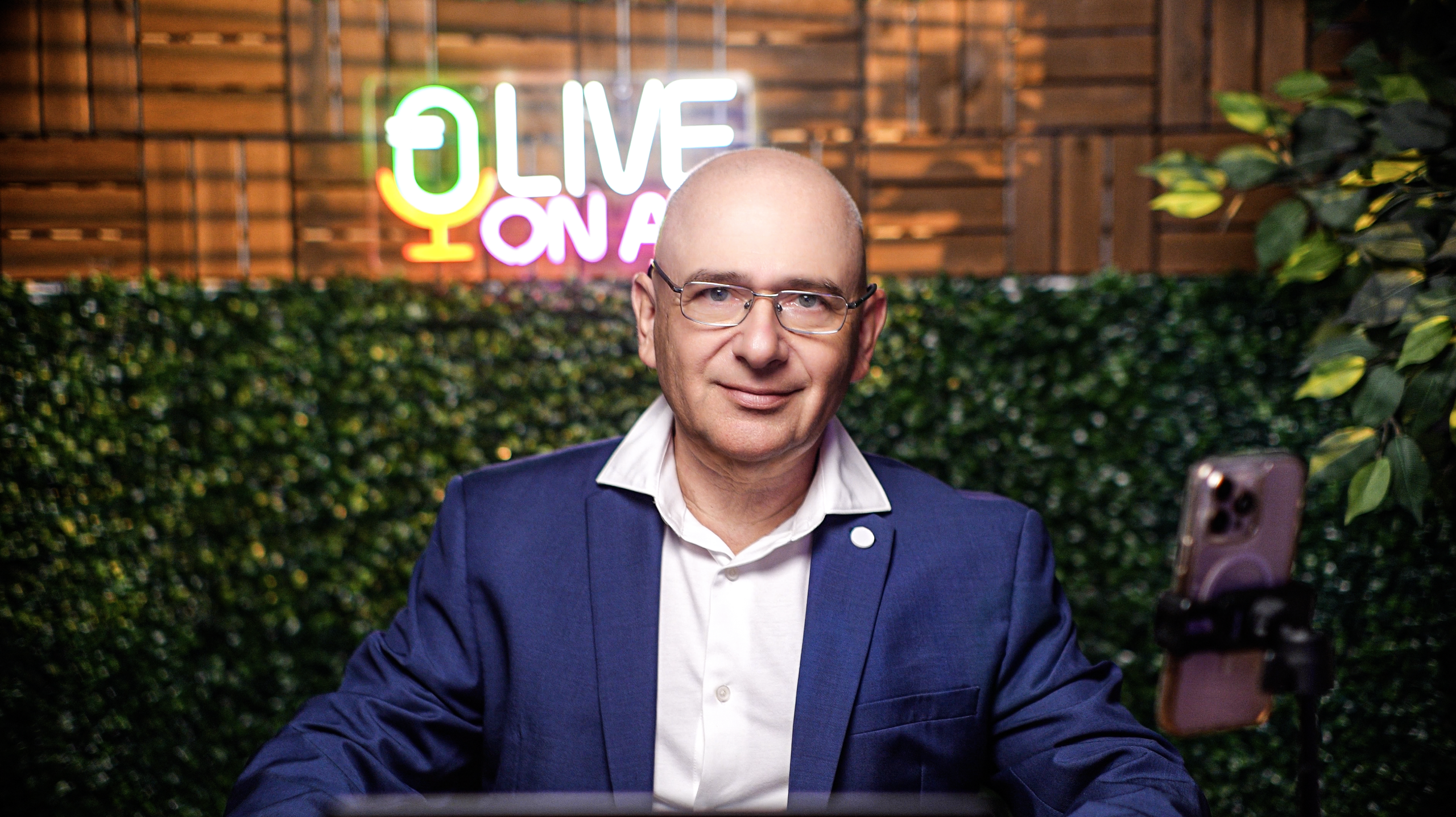 Livestream podcast setup at ProStudio1, Hollywood FL — host on camera with “LIVE ON AIR” sign and studio lighting for interviews and online content.