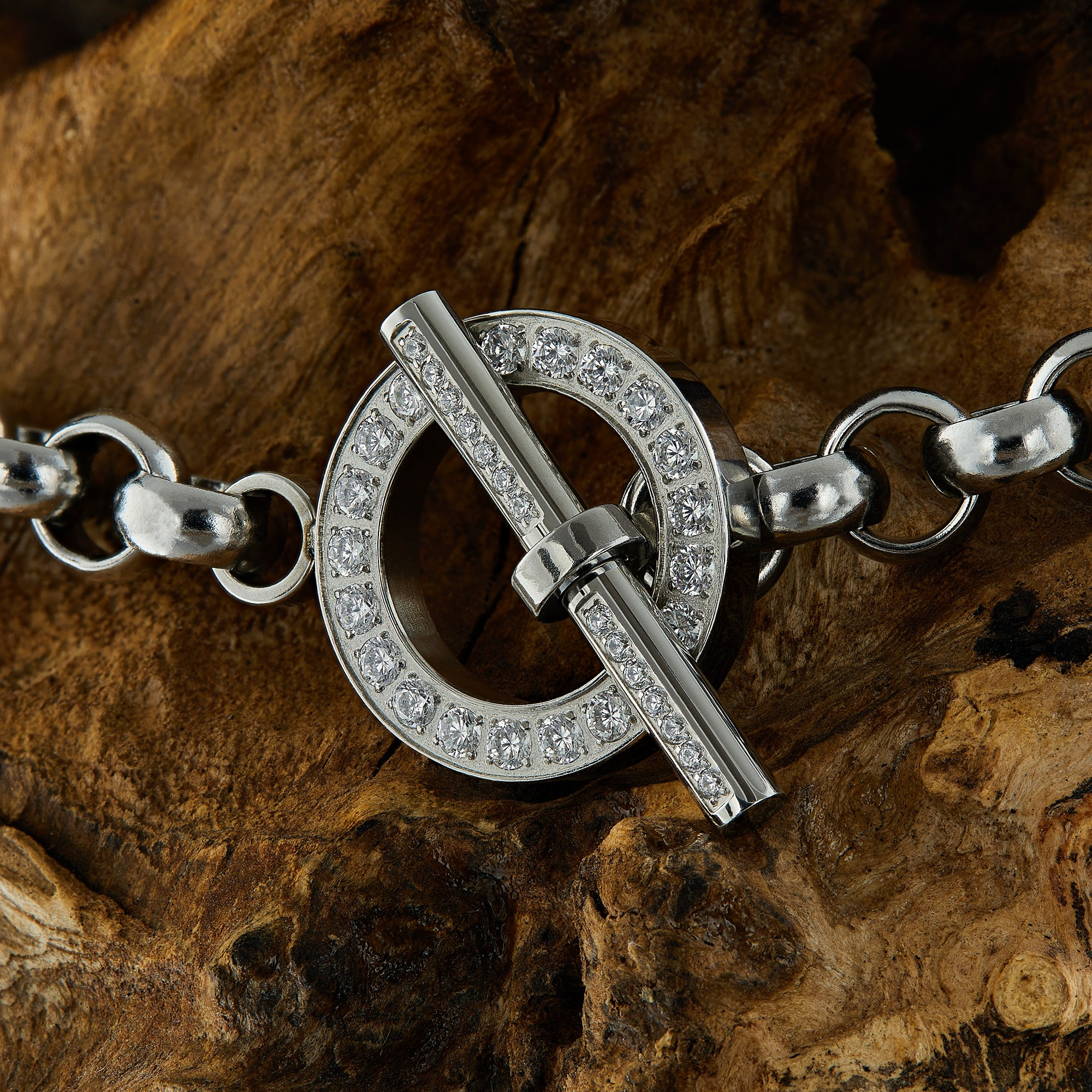 Photographer Roman Djuzev - Luxury Qudo Ceccato bracelet on a wooden background, close-up.
