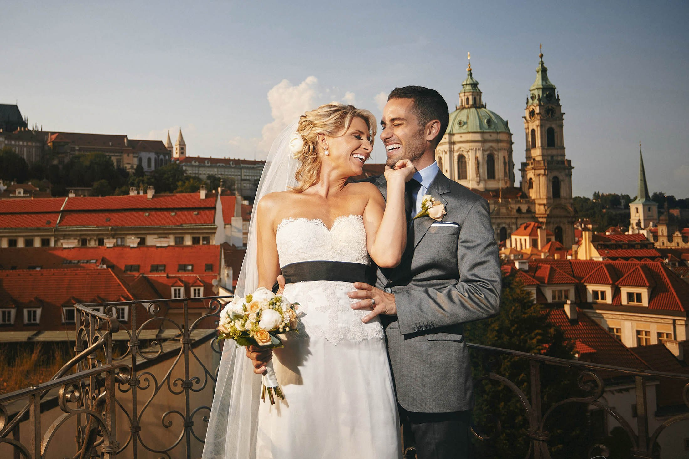 Joyful bride touching groom’s face in golden light, Vrtba Garden wedding